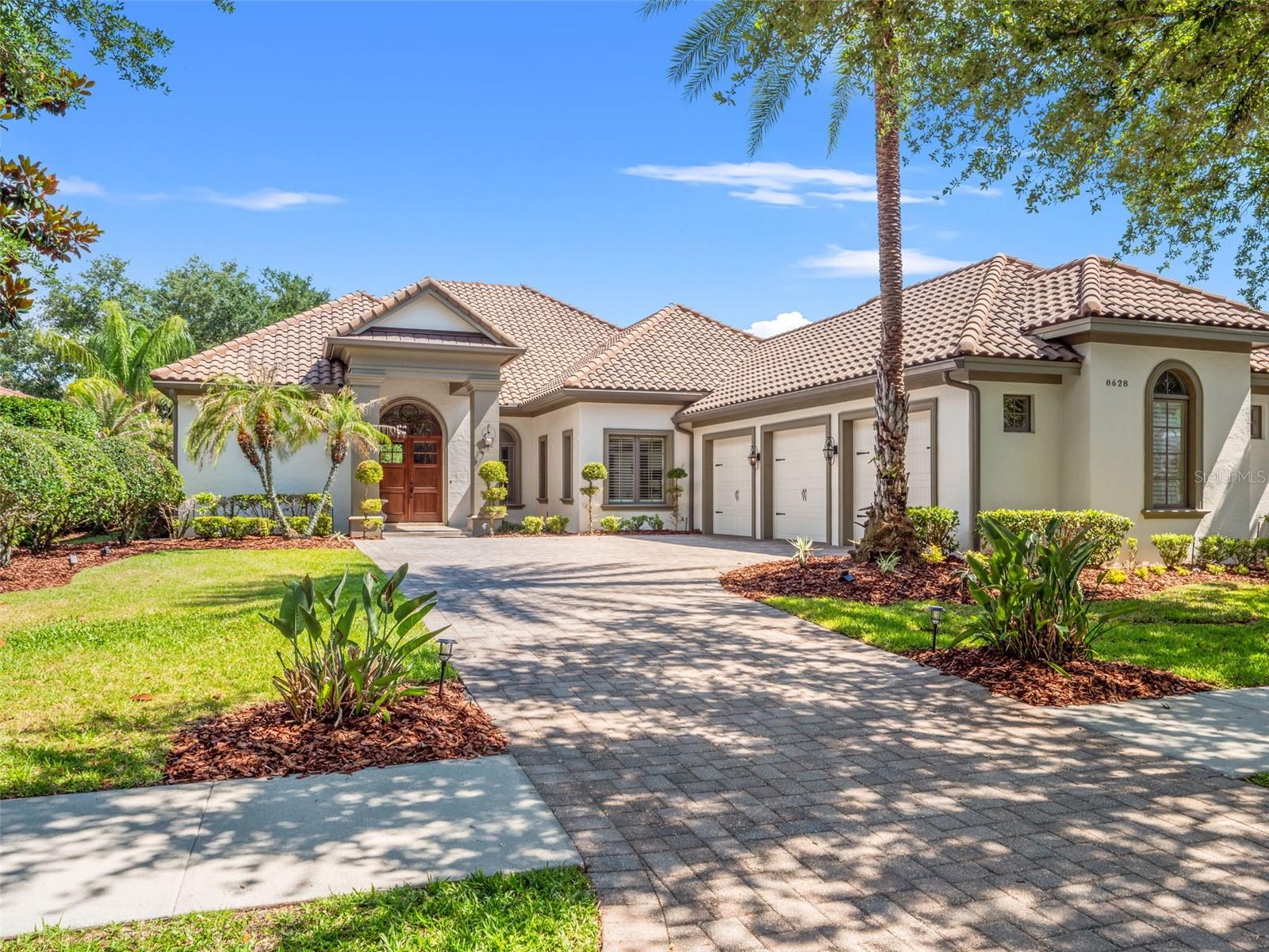 One or more photo(s) has been virtually staged. Welcome to an exceptional luxury pool residence offering 4 bedrooms, 4.5 bathrooms, a dedicated office, bonus room, and a spacious 3-car garage across 3,559 square feet of beautifully curated living space. Perfectly positioned on a private 0.34-acre homesite with tranquil pond views, this stunning home, built in 2014, seamlessly blends timeless elegance with gorgeous modern design. Designed with an open yet functional split-bedroom floor plan, the residence showcases refined finishes, thoughtfully designed spaces, and seamless indoor-outdoor living throughout. Upon entering, expansive living areas are filled with natural light and elevated by beautiful ceiling details, a statement chandelier, and oversized sliding glass doors that fully open to the outdoor oasis beyond. At the heart of the home, the gourmet kitchen was designed for both everyday living and elevated entertaining. Featuring an oversized island with designer pendant lighting, abundant seating and prep space, and a spacious walk-in pantry, the kitchen flows effortlessly into the main living and dining spaces, creating a warm & cozy atmosphere. Privately situated just off the living room, the dedicated office features custom built-ins, offering a refined work-from-home environment. The bonus room, also complete with custom built-ins, provides endless flexibility as a media lounge, game room, fitness space, or secondary entertaining area. The luxurious primary suite serves as a peaceful retreat, while the secondary bedrooms are thoughtfully positioned throughout the home for comfort and privacy. Throughout the residence, custom closet organizational systems provide both beauty and functionality, while the large laundry room adds convenience with generous storage and workspace. The outdoor living experience is truly exceptional. Designed as a seamless extension of the interior, the covered lanai features rich tongue-and-groove ceilings, a fireplace, summer kitchen, and motorized screens, creating a year-round outdoor living and entertaining space. Overlooking the sparkling pool and serene pond views, the backyard offers a private resort-style setting ideal for both intimate evenings and large gatherings. With its elegant architecture, thoughtfully curated details, luxurious outdoor living, and picturesque water views, this extraordinary residence offers refined Florida living at its finest. Don’t miss out on this opportunity! Ideally located just minutes from Orlando International Airport, Lake Nona Medical City, USTA National Campus, Boxi Park, and top-rated A-schools, this property also offers easy access to the 417 Greeneway and 528 Beachline. Don’t miss out on this opportunity!