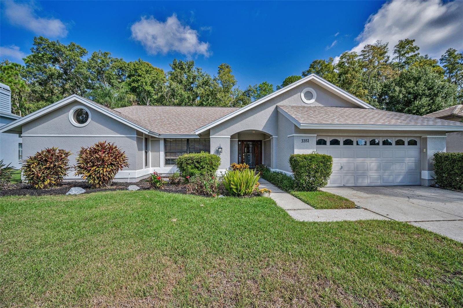 WELCOME TO WOODFIELD LAKESHORE VILLAGE AN EASTLAKE PREMIER COMMUNITY.  NESTELED IN A GEM OF A CUL-DE-SAC WITH TOTAL PRIVACY THAT BACKS TO CONSERVATION, THIS POOL HOME HAS GREAT CURB APPEAL WITH 4 BEDROOMS, 2 BATHS, 2CAR GARAGE.  ENTER THROUGH A WELCOMING BEVELED GLASS DOOR ENTRY INTO A LARGE FORYER WITH COAT CLOSET.  FRENCH DOORS LEADS TO AN OVERSIZED LIVING ROOM WITH CLOSET THAT CAN ALSO BE USED AS OFFIC/DEN.  VAULTED CEILINGS IN THE FAMILY ROOM WITH WOOD BURNING FIREPLACE.  KITCHEN WITH WARM WOOD CABINETRY THAT OVERLOOKS THE FAMILY ROOM AND DINETTE.  NEWER STAINLESS APPLIANCES WITH GRANITE COUNTER TOPS AND BREAKFAST BAR.  RELAX IN THE DINETTE WITH MORNING COFFEE TAKING IN VIEWS OF THE POOL AND LANAI.  SEPARATE FORMAL DINNING ROOM.  PRIMARY BEDROOM HAS WALK-IN CLOSETS, EN SUITE BATH WITH DOUBLE VANITY, GRANTE COUNTER TOPS, WALK-IN SHOWER AND PRIVATE TOILET CLOSET.  THREE LARGE GUEST BEDROOMS ARE LOCATED ON THE OPPOSITE SIDE OF THE HOME WITH SECOND BATH WHICH ALSO GIVES CONVENIENT ACCCESS TO THE POOL.  INSIDE LAUNDRY ROOM WITH FULL SIZE WASHER/DRYER AND UTILITY SINK FOR EASY CLEAN UPS.  THE HOME IS CARPET FREE WITH CERAMIC TILE AND LAMINATE FLOORING THROUGHOUT.  GLASS SLIDERS GIVE EASY ACCESS FROM THE PRIMARY BEDROOM, DINNING ROOM AND KITCHEN TO THE EXTRA LARGE COVERED AND SCREENED LANAI WHICH GIVES AMPLE SPACE TO RELAX POOLSIDE.  FENCED OPEN AIR PATIO SITS AT THE FOOT OF THE CONSERVATION AREA.  ADDITIONAL FEATURES OF THE HOME ARE RESCREENED BIRDCAGE 2024, WATER HEATER, WATER SOFTENER, ROOF AND SKYLIGHTS REPLACED 2023.  THE A/C IS 5 YRS OLD.  CLOSE TO BOTH TAMPA INTERNATIONAL & ST. PETE/CLEARWATER AIRPORTS, TARPON SPRINGS BEACHES, SHOPPING AND ZONED WITH TOP RATED SCHOOLS.  THIS HOUSE IS A MOST SEE!