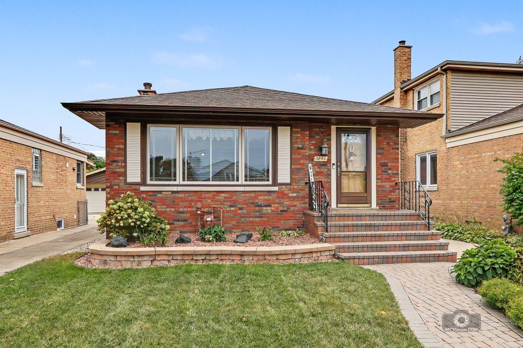 Beautifully maintained brick raised ranch with rear addition on a quiet, desirable block in Mount Greenwood! From the moment you arrive, the curb appeal stands out with a charming paver porch and beautifully landscaped yard. Step inside to a warm and inviting home that has been thoughtfully updated while maintaining its classic character.    The updated kitchen features beautiful custom Amish cabinetry, providing both exceptional craftsmanship and functionality. Updated bathrooms add to the home's move in ready appeal. The main level offers three comfortable bedrooms, while the finished basement provides additional living space with the flexibility to accommodate a possible fourth bedroom, home office, guest space, or recreation area.    Beautiful from the outside in, this home offers a wonderful combination of charm, updates and versatility in a peaceful Mount Greenwood location. A home you'll be proud to call your own!