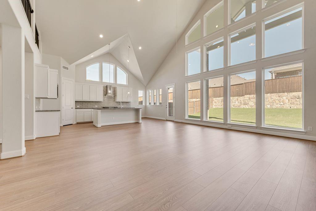 Discover this stunning new construction Grand Home in Monterra, a thoughtfully designed master-planned community offering a swimming pool, splash pad, scenic trails, park, and pickleball courts. Located in the highly acclaimed Rockwall ISD and within walking distance to the pool and pickleball courts, this home combines luxury, comfort, and convenience.The chef’s kitchen is a standout, featuring a spacious island, Shaker-style cabinetry, a full bowl sink, granite slab countertops, stainless steel appliances, a five-burner gas cooktop, large island and a walk-in pantry—perfect for everyday living and entertaining. The open-concept family room is filled with natural light from a wall of energy-efficient windows for lots of natural light and centers around a cozy gas fireplace.Versatile living spaces include a downstairs media room that can also serve as a formal living area or home office. The primary suite is a private retreat with a spa-like bath, complete with a freestanding tub, glass-enclosed tile shower, dual rectangular sinks, and a large walk-in closet. A guest suite is also conveniently located on the main floor.Upstairs offers a spacious game room and a bonus area ideal for a playroom, home gym or second living space. Enjoy outdoor living with a covered back patio, perfect for relaxing or entertaining guests.Additional features include 8-foot interior doors, Energy Star certification with R38 insulation, and a tankless water heater. Situated near Lake Ray Hubbard with easy access to shopping and dining, this home offers the perfect blend of upscale living and suburban charm.