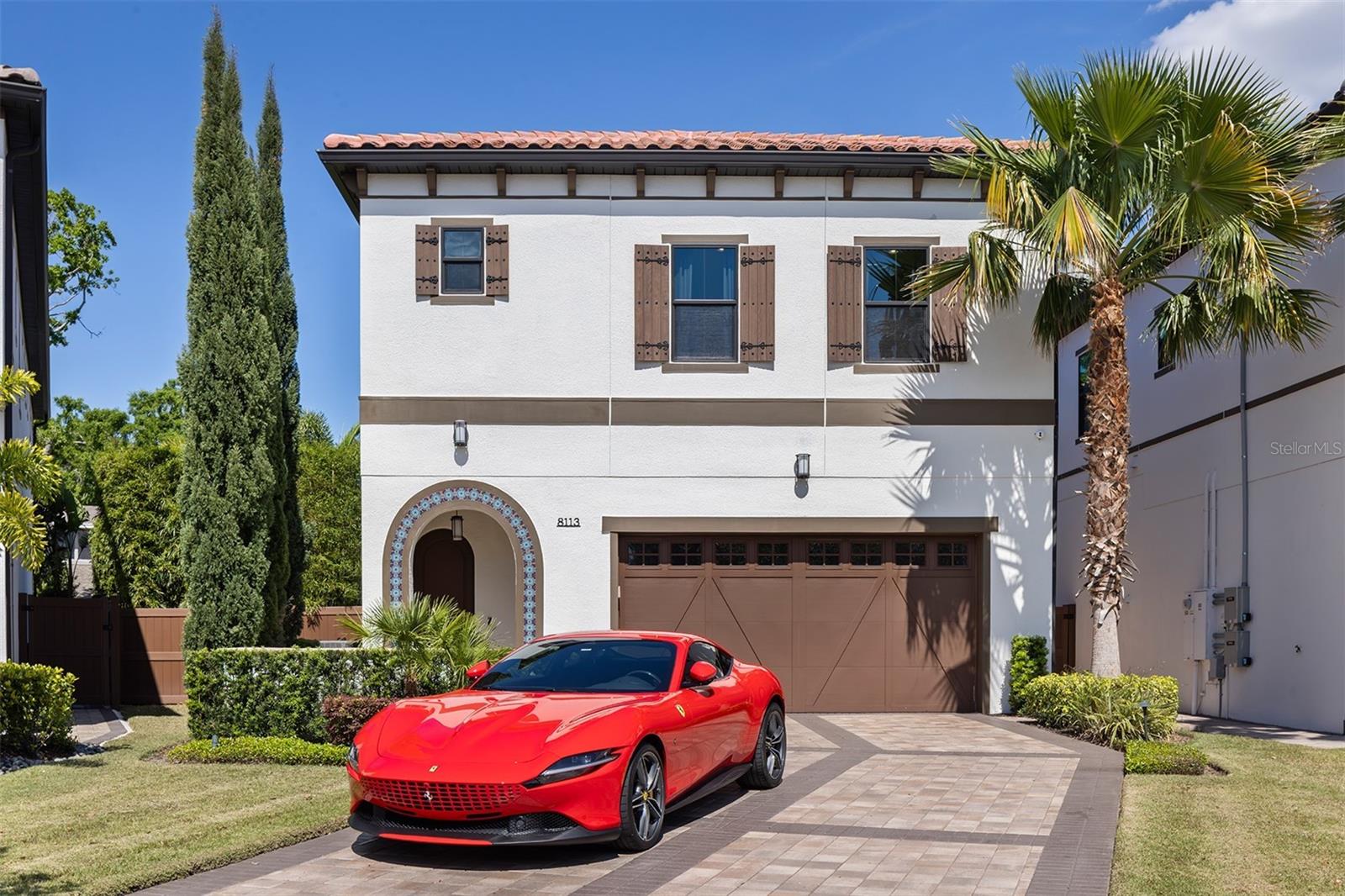 Under contract-accepting backup offers. Luxury Living in the Heart of Orlando’s Coveted Dellagio Community

Discover the perfect blend of urban convenience and single-family comfort in this beautifully appointed residence located in the gated enclave of Dellagio. Boasting 4 bedrooms, 4.5 bathrooms, a 2-car garage, and one of the largest private yards in the neighborhood, this home is a rare find.

Step inside and be greeted by designer wallpaper, rich wood flooring, and abundant natural light streaming through expansive windows. The dining area flows effortlessly into a tranquil open-air courtyard—an ideal space for al fresco meals or quiet mornings with coffee. The chef’s kitchen impresses with 42-inch cabinetry, quartz countertops, a full-height designer backsplash, and premium stainless steel appliances.
The great room is a showstopper, featuring soaring volume ceilings, dramatic sliding glass doors, and custom TV wall detailing that elevates the space with character and openness. Tucked at the rear of the home, the junior suite offers a private retreat with a walk-in closet and en-suite bath.Upstairs, a second en-suite bedroom welcomes you with generous light and comfort, while the catwalk leads to a spacious bonus room with custom built-ins—ideal as a media room or home office. Designer curtains valued over $50,000 are included throughout the home.The primary suite is a true sanctuary, with a sprawling bedroom, oversized walk-in closet, and a spa-worthy bath complete with dual vanities and a luxurious “car wash” shower. Outside, enjoy a rare oversized yard perfect for entertaining, dining under the stars, or even adding a private pool.
All this, just steps from Orlando’s famed Restaurant Row on Sand Lake Road and minutes from world-class theme parks, attractions, and shopping. Don’t miss your chance to own a home that blends privacy, luxury, and location in one of Central Florida’s most desirable communities.