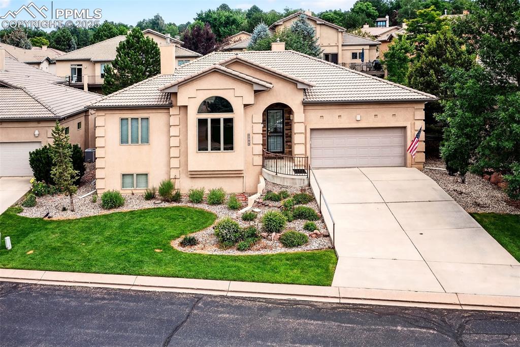 Welcome to this absolutely stunning home within a gated community surrounded by 36 well cared for homes!  Ranch style, with 4 bedrooms, 3 bathrooms, and a 2 car garage.  So many upgrades and special touches!  New carpet throughout and paint in the main level!  Large master bedroom with attached 5 piece master bathroom with a soaking tub located on the main level, canned lighting throughout, central A/C, marble double-sided fireplace in the living room and master bedroom, gourmet kitchen with gas stove upgrade, hands-free kitchen sink faucet, built-in wall cubbies throughout the home, lots of storage areas, family room with wet bar and mini fridge, refinished hardwood floors in kitchen, all new ceramic tile in the bathrooms, new brushed stainless steel hardware, upgraded water distribution system, Pella windows throughout, insulated garage, and spectacular Pikes Peak views from the huge picture window in the living room!!!  The natural gas BBQ grill will stay, as well as the Kobalt work bench in one of the storage areas in the basement.  Low maintenance front or backyard!  HOA takes care of all mowing!  This truly is a remarkable home - come in and call it Home!