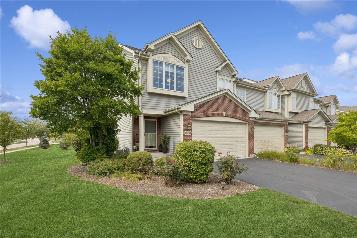 Bright, well maintained end unit townhome with southern and western exposure! Roomy kitchen w/stainless steel  appliances, granite countertops & 42" cabinets with separate eating area. Main floor features hardwood floors & vaulted ceilings. Loft/office above living room leads to spacious primary suite w/full bath, soaking tub and shower.  HUGE Custom Walk in Closet!  Finished Walk-Out Basement has separate family room, 2nd bedroom, full bath, utility/laundry room and large lighted crawl space for storage. Deck w/Sunsetter awning & patio.  Epoxy floor and slat wall organizer system in the 2 -Car Attached Garage. One block to area park and forest preserve with walking trail.