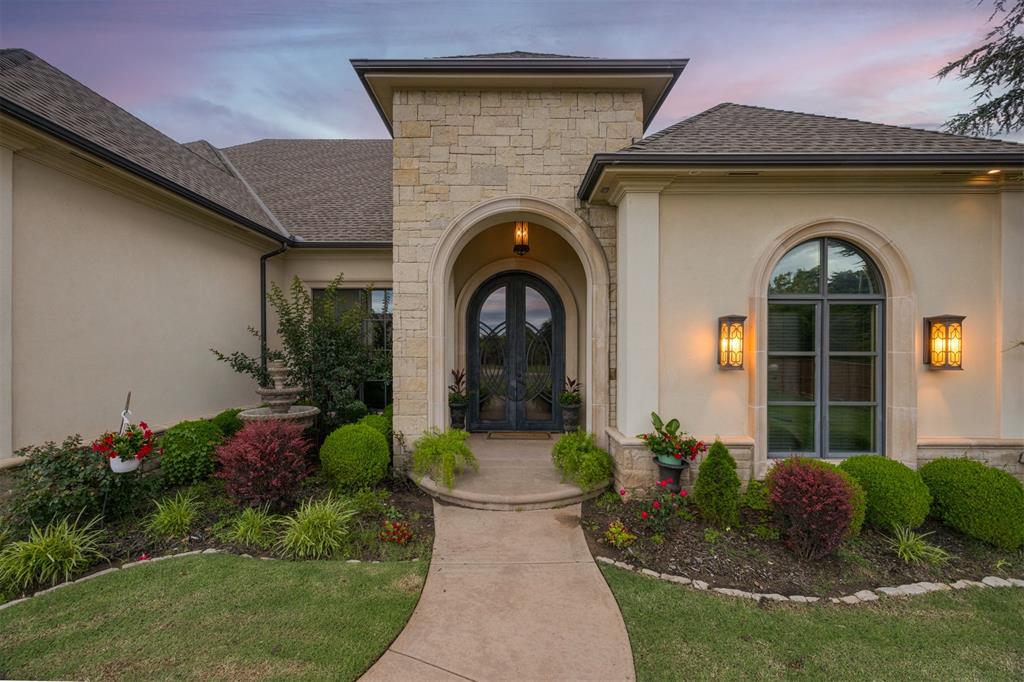 This one-of-a-kind, custom built home, is a standout in north Edmond. As you pull into the gated neighborhood and drive the tree-lined streets, you arrive at the beautiful Stagmoor estate. The manicured yard, large windows and modern elevation are show stoppers. The lot boasts over 3/4 acre and is one of the biggest in the neighborhood. Step through the custom iron front doors into the openess of the main living space. Invite the friends & family over as the dedicated formal dining space is large enough for a crowd and is open to the mail living area. Gather around the fireplace to enjoy time together while entertaining in the kitchen and large wrap-around bar area. The chef's kitchen is specially designed with all the bells and whistles, including granite countertops, custom vent hood, plenty of storage and a walk in pantry that doubles as a safe room. The eat-in kitchen area is perfect for those more intimate family dinners. The built-in office space is tucked away, out of site, and is perfect for keeping the household organized. The extra living space is one of a kind with surround sound, projector hook up, and ready for the next movie night. The spacious primary bedroom faces the backyard and is perfectly paired with the en-suite bathroom. Each vanity has its own space and a featured accent wall for the bathtub and walk around shower. Both secondary bedrooms have their own full bathroom and are spread out giving each area its own privacy. As you step out onto the back patio, the view is amazing with its own retreat. The covered back area has a built-in grill, surround sound, bar top and is ready for a pool party. The large pool is ready for the summer with a built in slide and diving board. Another covered area gives plenty of room for guests to be in the shade. A large grassy area is perfect for volleyball, trampoline and for the kids and dog to run around. Don't miss out on this one of a kind, before it's gone!