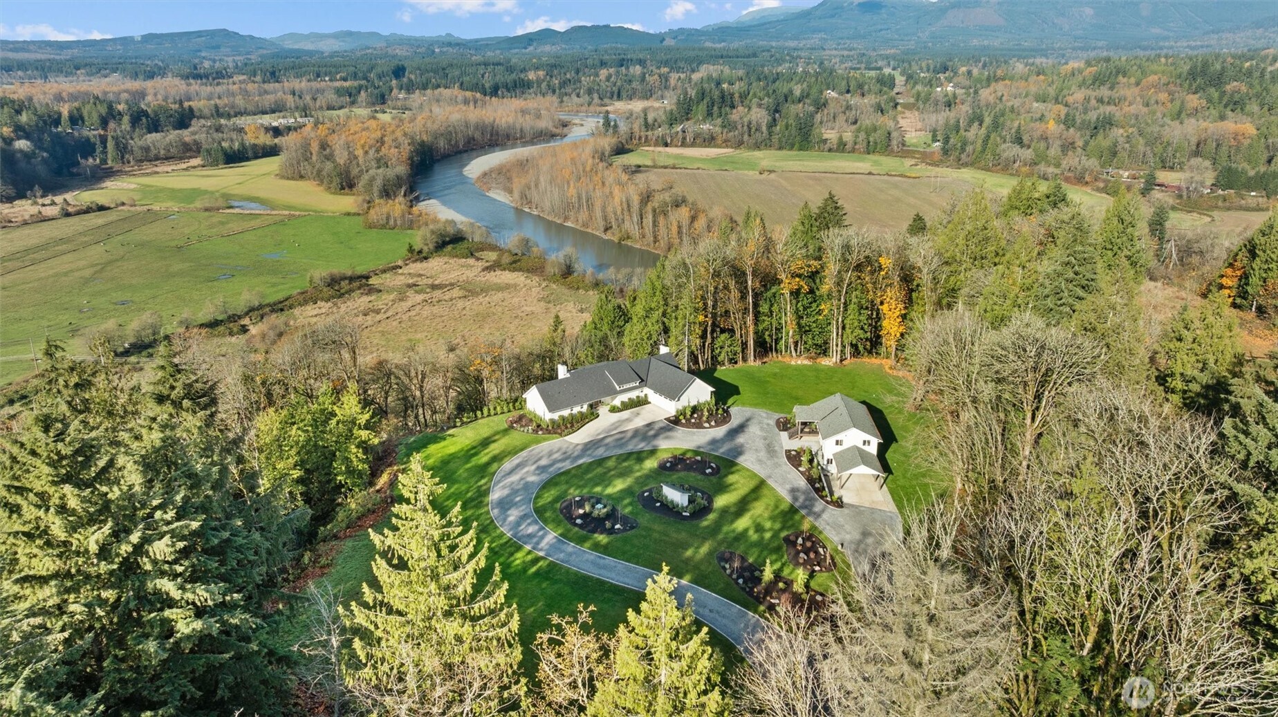 Nestled in a private, serene setting, this breathtaking French Country-inspired estate offers a harmonious blend of timeless elegance and modern amenities. Behind a custom iron gate, this spectacular property spans 18.5 acres of parklike grounds adorned with old-growth trees, professional landscaping and sweeping territorial views of the mountains and river beyond. This meticulously remodeled estate encompasses two distinct homes with almost 6,000 sq ft of total living space and a 960 sq ft heated shop. Thoughtfully designed with only the finest materials, including marble, natural stone, high-end appliances and custom finishes throughout. This one-of-a-kind estate offers a lifestyle of unparalleled tranquility. Virtual tour is a must see!