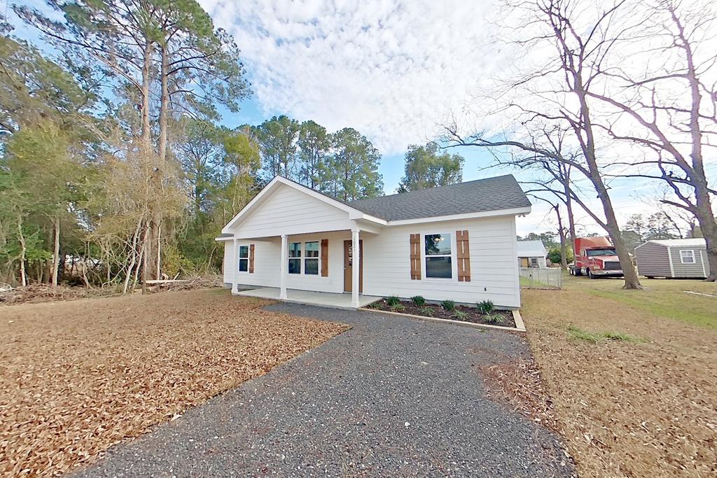 Welcome home to sweet Southern living at this beautifully built new home at 1021 11th Ave NW in Moultrie, GA. From the moment you step inside, the vaulted ceilings and open floor plan create a light-filled, welcoming space that feels just right for everyday living and gathering with loved ones. The living, dining, and kitchen areas flow together effortlessly—perfect for suppers, celebrations, or quiet evenings at home. Thoughtful woodwork and quality craftsmanship are woven throughout the home, adding warmth, character, and a sense of care you can truly feel. The kitchen and baths feature timeless quartz countertops paired with clean, well-finished details, while the spacious primary suite offers a peaceful retreat with a generous walk-in closet. The utility room is both practical and well-designed, complete with a washer, dryer, and pantry shelving to keep daily life organized. Step outside to a fenced backyard with an 8-foot double gate, offering privacy and flexibility for entertaining or outdoor projects. And of course, the front and back porches—finished with classic tongue-and-groove wood ceilings—are made for rocking chairs, sweet tea, and slowing down at the end of the day. This home blends modern comfort with true Southern craftsmanship and hospitality, ready to be loved from day one.