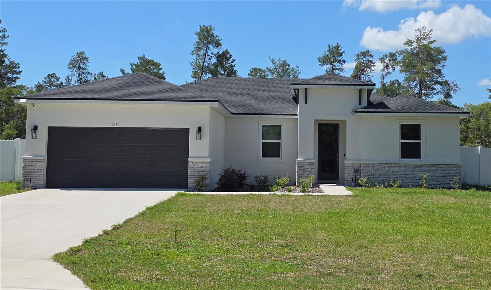 Brite Sunrise Model by Brite Homes! Highly sought after Marion Oaks community! This beautifully single-story Ranch-style home sits on a generous 0.71-acre (3/4-acre) lot with no back neighbors, offering incredible privacy with a vinyl fence and room to enjoy Florida’s outdoors. Built in 2025 with durable concrete block (CBS) construction, stucco and stone accents, and a concrete slab foundation, this home is move-in ready. Inside, the 1,787 sq ft open-concept floor plan features 4 bedrooms, 2 bathrooms, and a split-bedroom layout perfect for families or guests. Soaring 9’4” ceilings, luxury tile plank flooring throughout, and an abundance of natural light creates a bright, airy feel. The chef’s kitchen shines with 36” real wood cabinets, elegant quartz countertops, stainless steel appliances, and a spacious island—ideal for entertaining.  The master bedroom offers a large walk-in closet; this primary suite provides a true retreat. Energy efficiency is built in double-pane low-E windows to help control indoor temperature and reduce noise pollution, LED lighting, and a high-performance 16 SEER HVAC system deliver comfort and savings. This home achieves a strong HERS score of 53, translating to lower utility bills year-round. Outside, enjoy designer landscaping and a full irrigation system on this oversized irregular lot. The north-facing front elevation provides balanced light, while the open backyard is perfect for a future pool, garden, or simply relaxing under the stars. Additional highlights include a 2-car garage and modern finishes throughout. No HOA. No CDD. Just low-maintenance living with county-maintained roads and the convenience of the Marion Oaks MSTU for neighborhood services. Located in desirable Ocala, FL 34473, you’re minutes from shopping, dining, hospitals, and major highways, yet tucked away in a peaceful setting. This is new-construction living at its best—modern, efficient, and worry-free. Don’t miss your chance to own this exceptional home!