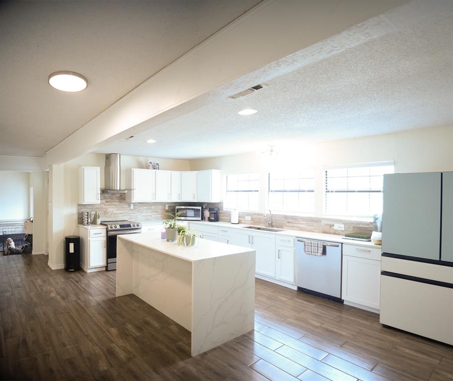 This beautifully renovated home that boasts well over 2,000 square feet of living space and features many upgrades. As you step into the home, you'll be greeted by an abundance of natural light, an open floor plan, and a spacious kitchen island. The kitchen has been fully upgraded with new appliances and an oversized island, perfect for entertaining guests. The entire home was remodeled in 2024, complete with a new HVAC system, water heater, new flooring, and updated bathrooms. The main bathroom is spacious and features a beautiful, fully updated walk-in shower with dual shower heads – perfect for relaxing after a long day. This home is one of the largest in the area, both in terms of square footage and lot size. The large backyard provides a relaxing space for evenings on the covered patio deck, and a privacy wooden fence recently. The backyard also includes a dog run for your furry friends. Survey available