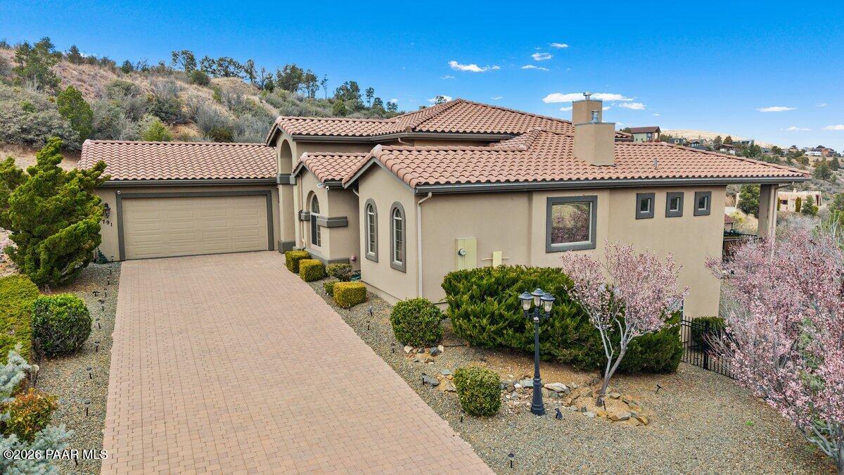 NEW PRICING! Stunning custom home located in the beautiful Creekside area of Prescott. This amazing home is situated at the end of a Cul-de-sac and borders BLM. The moment you enter through the majestic 9 ft iron doors you can tell that every inch of this home was meticulously crafted to blend sophistication and opulence, while maintaining a warmth that soothes your soul. The main level living area boasts Brazilian cherry wood floors, a chef's dream kitchen with granite counters and top end appliances and a massive walk-in pantry. The living room captivates with breathtaking views and a floor to ceiling stone fireplace.  Just off the front entry is a beautiful office/den, perfect for those who work from home or even a private reading area. Retreat to the expansive master bedroom with its spa inspired bathroom and double sided fireplace for added ambiance. The lower level of the home was thoughtfully designed for multigenerational families. Guests can enjoy a generous living area, second master bedroom, additional ensuite bedroom, kitchenette with additional workspace and laundry room. There is a private entrance and multiple access areas to the lower level patio and more amazing views! The owners had the backyard extended, allowing for additional landscaping and usable land, a rare find in the hills of Prescott! The expansive paver driveway leads to a 3.5 car garage with ample storage space. For those with a green thumb, you'll love the enclosed garden area and fruit trees. Too many features to mention in such a limited space. You need to see for yourself all the beauty and charm this home has to offer! SOME FURNITURE AVAILABLE TO BUYERS BASED ON PURCHASE PRICE.