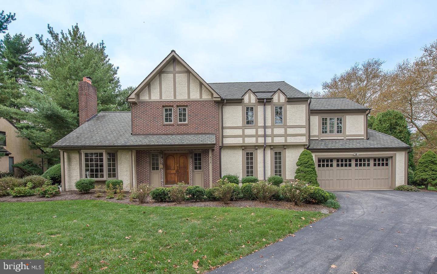 Nestled on a quiet, tree-lined street within Lower Merion's sought-after Choice Zone, this beautifully renovated Tudor sits on a professionally landscaped half-acre lot — a rare find that blends timeless character with modern refinement. Walk to Narberth's charming downtown, including the library, restaurants, & quaint shops. Penn Valley Elementary, the train to Center City, and I-76 are all just moments away.One of the home's defining features is its inspired layout: three distinct living spaces unified through an open-concept design. A grand foyer anchored by floor-to-ceiling library shelving flows into a sun-drenched morning room and chef's kitchen — dressed in warm custom wood cabinetry, ivory white walls, and tumbled travertine stone floors. From there, a sweeping 26' x 26' Great Room draws the eye toward an expansive picture window, framing the backyard's ever-changing seasonal palette.Step inside through elegant front double doors into a vestibule with a custom coat closet and a powder room. The living room charms with a gas fireplace set beneath an antique mantel and a bay window with a built-in window seat. Beyond the foyer, a private library with floor-to-ceiling shelves, a dedicated office with built-in desk and cabinetry, and a kitchen nook provide inspired spaces to work and unwind.The chef's kitchen is outfitted with Bosch, Wolf, and ASKO appliances, granite countertops, a tumbled travertine backsplash, a marble pastry table, and a stunning wall of glass-front floor-to-ceiling cabinetry. A formal dining room adjoins the kitchen.The sky-lit morning room, with its soaring vaulted ceiling, comfortably accommodates a large dining table and opens through double doors to the deck and brick patio. The Great Room echoes the drama with vaulted ceilings, bold statement lighting, hardwood floors, a limestone gas fireplace, and its own set of patio doors. A well-placed laundry and mudroom off the kitchen features a soapstone deep sink, generous utility cabinetry, and direct access to the two-car attached garage.Upstairs, the primary suite offers a luxurious custom walk-in closet, a striking board-and-batten charcoal accent wall, and a spa-inspired en-suite bath with a jetted tub and double vanity. Three additional bedrooms  two with custom closets  and a large hall bath with a double vanity round out the upper level.Thoughtful upgrades throughout include Pella replacement windows, plantation shutters, custom closet organizers, a three-zone HVAC system, and a dedicated gas line to the patio's built-in Weber grill. Make your appointment today!