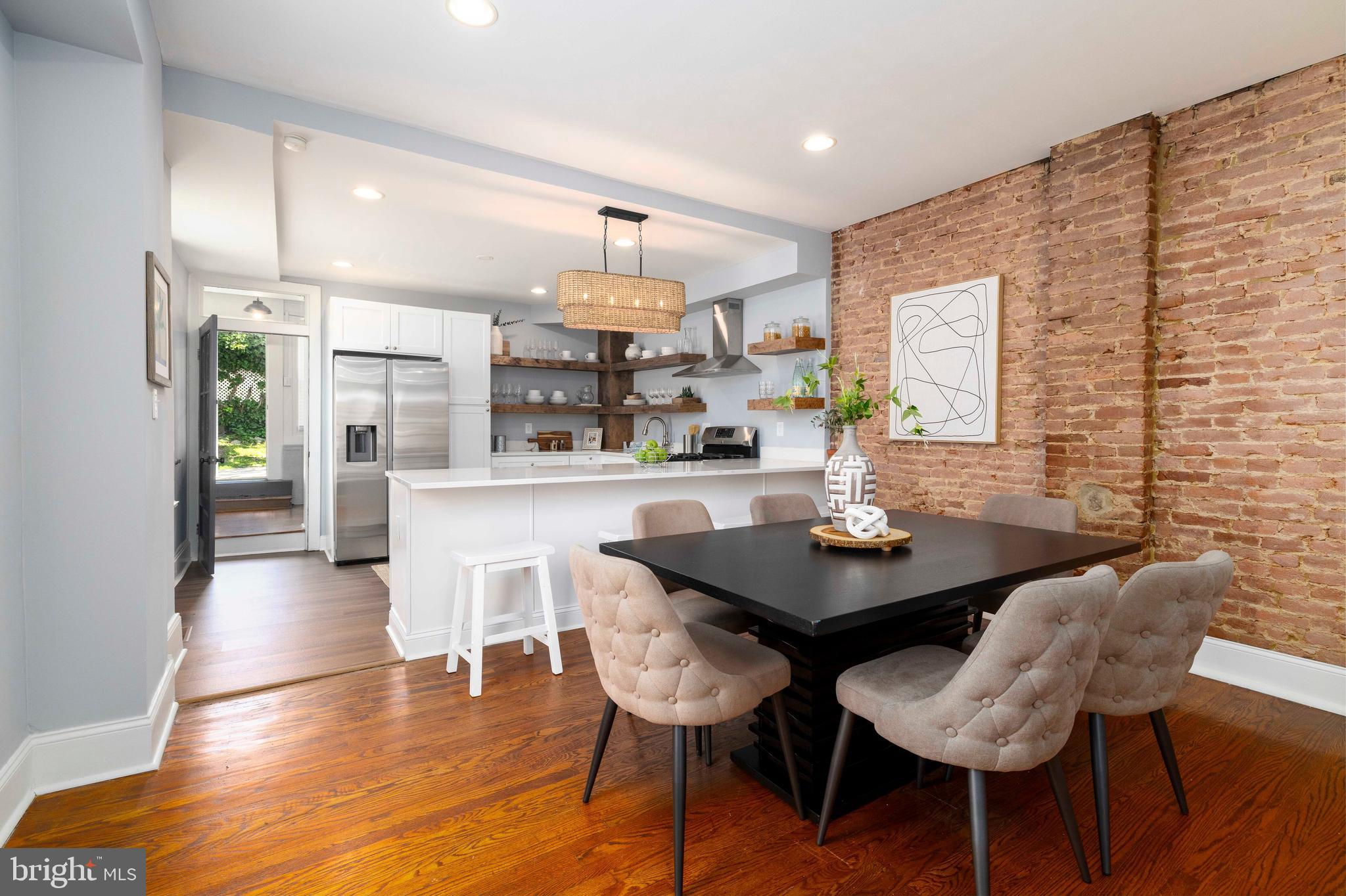 Renovated 3 story corner home with 2 PARKING SPOTS right in front of the house in the highly desirable Germany Hill section of Roxborough. Renovations include a brand new kitchen and a  blend of original finishes like brick walls, hardwood floors and claw foot tub along with modern updates throughout. Pull into one of the two parking spots and enter through your garden into the mudroom. You will notice the refinished red pine floors and 1st full bathroom conveniently located on the 1st floor (think pooch or kids hosing down!). You will then be in the the fully renovated kitchen with new stainless steel appliances, stunning countertops and custom floating shelves. The main level boasts high 9 foot ceilings, recessed lighting and hardwood floors. On the 2nd floor you will find 3 large bedrooms, all with hardwood floors, modern ceiling fans and large closets. The 2nd full bathroom has double vanities, modern plank tile flooring and large stand-up shower with white subway tile throughout. The 3rd floor has the 4th bedroom on one side and a den with storage on the other side. Both rooms also have refinished red pine floors. Newer HVAC system with central air, and updated electric and plumbing throughout. The exterior of this house has recently been repainted with high quality waterproofing outdoor paint along with all new siding and insulation in the back. Full enormous basement includes washer/dryer combo a workbench and storage galore. Newer upgrades include the main roof that is 4 years old and there is a 3 year old washer. The Germany Hill trails are two blocks away and so is  the highly desirable Wissahickon Valley Park Trail. This house is surrounded with  farmers markets, Gorgas Park, shopping, bars, cafes, breweries, restaurants, and is 1 mile from Main Street Manayunk.