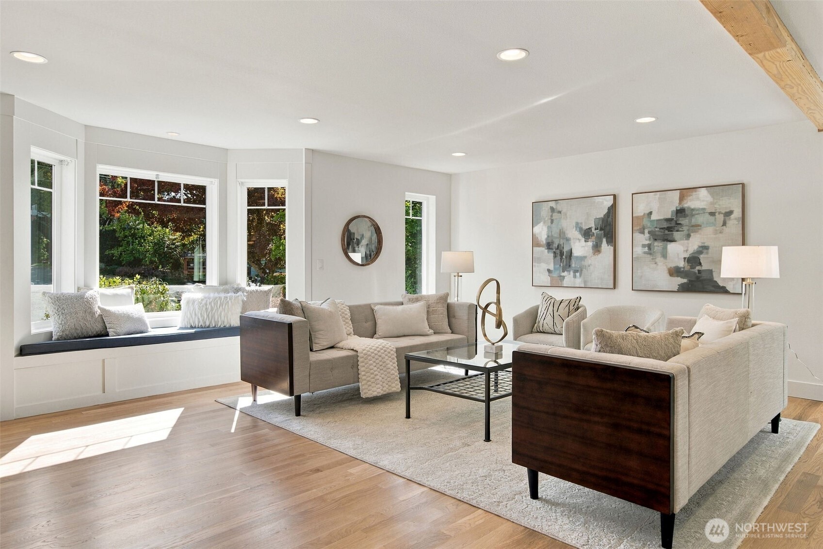 Oversized windows and a built-in window bench bring soft natural light into the living room all day.