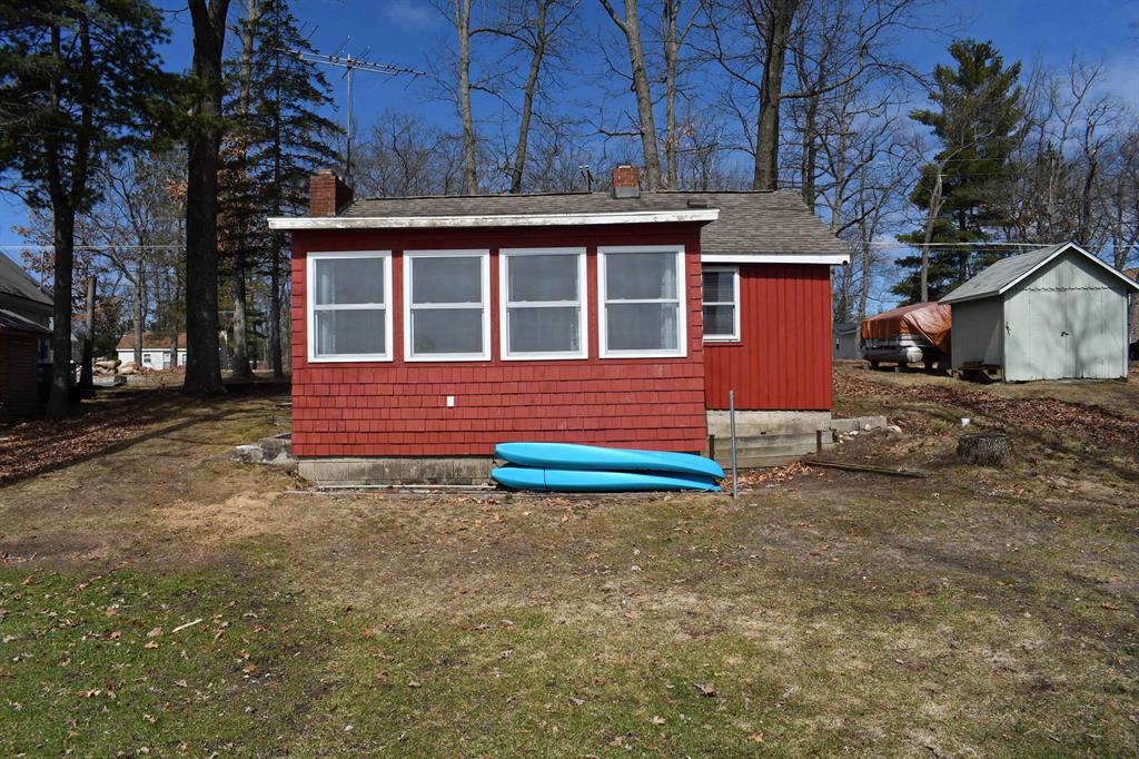 Your Affordable "Up North" retreat Awaits on All-Sports Little Island Lake! Nestled on the scenic shores of Little Island Lake in National City, this charming two-bedroom traditional cottage offers the perfect blend of cozy comfort and endless outdoor adventure. Whether you are looking for a weekend getaway, a hunting basecamp, or a peaceful summer haven, this waterfront property is ready to welcome you home. Whip up your favorite meals in the beautifully updated kitchen, offering modern convenience while perfectly complementing the home's classic charm. A traditional two-bedroom floor plan provides a warm, inviting space for family and friends. Beautiful and durable ceramic tile flooring runs seamlessly throughout the entire home, making lake-living cleanup a breeze. The beautiful fireplace anchors the living area, perfect for warming up after a crisp autumn hike or a day on the trails. Relax and take in the waterfront scenery from the spacious 7x14 three-season sunroom, perfectly positioned on the water side of the home. Located just minutes from the local ORV trailhead, granting you immediate access to Michigan's premier riding networks. Just a few minutes from your you will find thousands of acres of pristine state and federal land. You are just a short drive from the world-class fishing of the AuSable River and the beautiful sandy shores of Tawas Bay. Plus, countless local golf courses are nearby. If you have been searching for a reasonably priced "Up North" retreat that checks all the boxes for location, charm, and recreation, this may be the one! Don't miss your chance to own a slice of pure Michigan beauty.