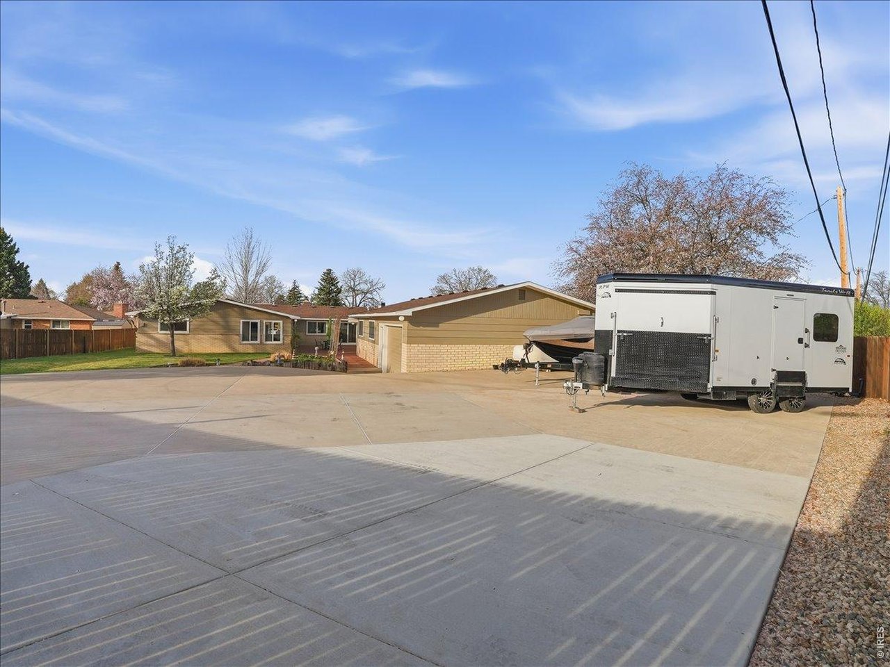 RARE OPPORTUNITY: Discover the perfect balance of traditional charm and massive utility on this sprawling .44-acre lot with NO HOA. This 2,106 sq. ft. rambler ranch offers a welcoming neighborhood feel, while the rear reveals a secure, high-capacity hobbyist's dream. An entertainer's delight, the expansive living area features a retro wet bar and floor-to-ceiling windows that flood the space with natural light while framing serene views of the private courtyard. The crown jewel is the attached 10-car heated shop, featuring a 3-phase converter-perfect for a massive car collection, woodworking, or a home-based trade. The rear workspace and garage entry are accessed via a private electronic gate with an integrated security perimeter, providing a secure, 'lock-and-leave' setup for your equipment and projects.