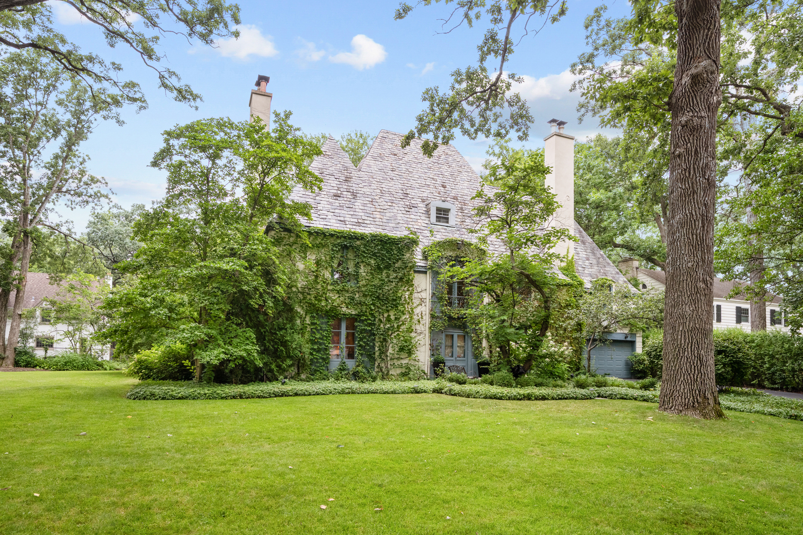 Welcome to this spacious 6 bedroom, 4.1 bath, 2-car attached garage home sitting on an expansive and spectacularly landscaped 1/2 acre lot! Enveloped by mature trees & lush landscaping, this home offers respite and tranquility inside and out. This magnificent French Provincial home boasts splendid architectural elements preserved amidst meticulous updates throughout. You are met with beautiful original details in every direction, from the carved wood fleur-de-lis internal doors & parquet wood flooring to the gorgeous hand painted walls & crown molding. The Living Room showcases an original carved wood & marble fireplace & reclaimed Vermont wood floors that extend into the sun-soaked Family Room, flooded with light from the large French doors, windows & skylight. The Kitchen features high-end appliances, a farmhouse sink, a large island, built-ins, & a Pantry. Off the Kitchen a large Mud/Laundry Room doubles as an additional prep space, offering a second refrigerator/freezer & dishwasher along with a laundry sink, washer & dryer, & ample storage space. A formal Dining Room, Home Office with a cozy gas fireplace, & a fully remodeled Powder Room complete the generous first floor. Ascending the sweeping staircase brings you to the second floor that offers five bedrooms & three full bathrooms. The renovated Primary Suite includes double closets, a separate dressing area with California Closets, & an updated Primary Bath with double sink & large shower. The spacious third floor provides flexibility in use, whether it be an Au Pair Suite & Gym, or second home Office & Recreation Room, or simply two additional Bedrooms. The partially finished basement offers additional recreational & storage space. Enjoy sitting luxuriously on the Flagstone patio taking in the gorgeous garden and vast lawn, which offers ample space to add a pool or even tennis/pickleball court! Sitting gracefully on a quiet, tree-lined cul-de-sac within walking distance to Glencoe village, West & Central Schools, its location can't be beat.