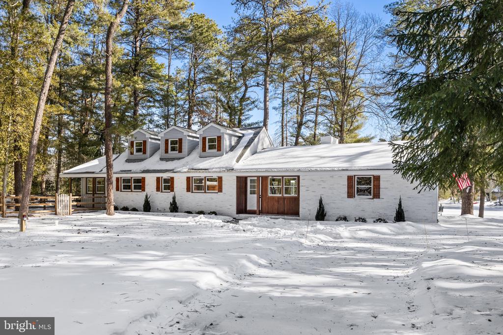 Lakefront!!! Absolutely Stunning 3 Bedroom, 2 Full Bath and 1 Partial Bath Ranch Style Lakefront Home in the Centennial Lake development of Medford Township. Centennial Lake is regarded as one of the top, if not the best, lake community in Medford known for the shear size of the lake and its endless views. This home is located on one of the best lots in the development with an expansive view of the main lake. This home has been completely renovated from top to bottom and everything in new including an all new septic system and an all new gas HVAC system  including all new ductwork. The interior of the home offers an open floor plan with views of the lake from every angle, all new wood flooring throughout the first floor, a large formal living room with cathedral ceilings and a brick (wood burning) fireplace, a newly updated partial bath off the living room, open to the living room is the dining room that is open to an all new custom kitchen with white shaker cabinets, granite countertops, stainless steel appliances, a tile backsplash, and a window above the sink that overlooks the backyard/lake, off the kitchen is a large family room with cathedral ceilings and a great view of the lake, there is a first floor primary suite that offers an all new custom bath with a walk-in glass shower, a double vanity, and a large walk-in closet. The second floor offers 2 large bedrooms both with beautiful views of the lake and an all new full bath. The exterior of the home boasts a huge 1+ acre lot with a long paved driveway that leads to a 2-car side turned garage, all new professionally installed landscaping, a new septic system, 2 covered porches, a fenced-in dog/pet area, a large outdoor shed, a whole house generac generator system for power outages, a large screened-in porch, a expansive backyard, and your very own dock that overlooks every angle of the lake. Don't miss your opportunity to see this wonderful home!