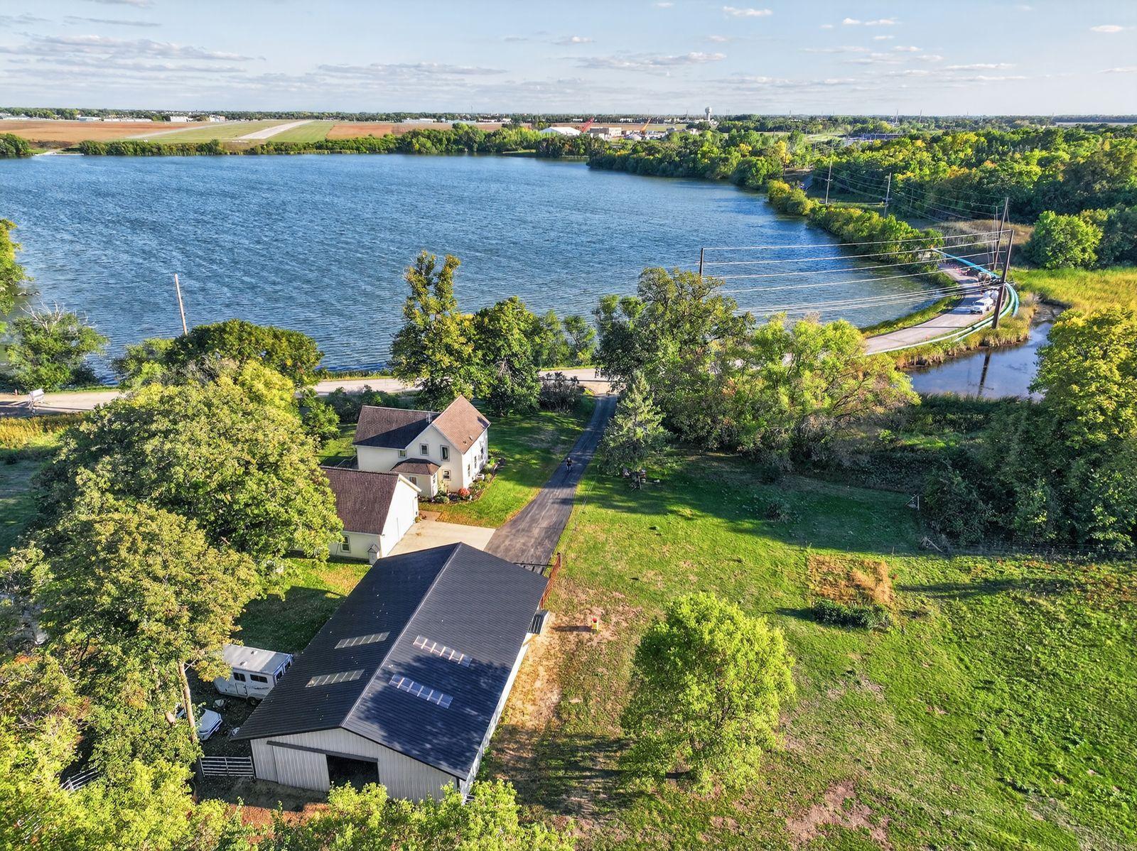 Farmhouse in the City at the Lake!Escape to the country without giving up the convenience of Alexandria. Tucked onto 5.1 acres with approximately 300 feet of shoreline on Lake Winona, this 4-bedroom home offers the space, privacy, waterfront, pasture, and outbuilding you’d expect to find miles outside of town—yet downtown Alexandria and the southern business district are only minutes away.Enjoy the character of a farmhouse with the feel of a much newer home. Remodeled to the studs in 2006, with the walkout level finished in 2016, the home has been thoughtfully updated while maintaining its comfortable farmhouse feel. Fresh interior paint, new custom window treatments, newer stainless steel kitchen appliances, and a new well pressure tank are among the recent improvements.But the real attraction is the setting. Wake up to the sunrise over Lake Winona, enjoy morning coffee from the lakeside kitchen or large deck, and end the day surrounded by acreage, pasture, and water—all within the city.The roomy walkout lower level adds another dimension to the property. With its own private entrance, bedroom, living area, kitchenette, and walkout access, it offers flexibility for extended family, guests, or separate living quarters—and potentially rental income to help offset ownership costs. Hydronic in-floor heat is installed in the lower level and ready to be put into service.And then there’s the new 40' x 60' barn and shop—a tremendous addition to an already unique property. Steel-sided with skylights, a concrete floor, electrical service, and a rear door opening directly to the pasture, it provides incredible space for horses, a workshop, equipment, recreational toys, storage, or a combination of uses.The seller has kept horses here, and the yard and pasture are newly fenced with electric fencing installed to follow the city’s agricultural fencing requirements. Imagine stepping outside your door to horses in the pasture, spending the afternoon in the shop, or paddleboarding, kayaking, or putting around Lake Winona on your pontoon—then being just minutes from everything Alexandria has to offer.Even the surrounding landscape brings something special to the property. The neighboring farmer staggers his crops, creating a changing backdrop from year to year—corn one season, pumpkins the next, followed by sunflowers. It’s an ever-changing country view right in the city.The City is currently completing sewer reconstruction along West Winona Road, temporarily affecting both entrances to the property. See listing photos for current access directions; these will be updated as construction progresses. The property has been connected to city sewer for several years, and the existing sewer service is functioning properly. There is no cost to the homeowner and no assessment for this project.Once construction is complete, the disturbed area is expected to return to its previous naturalized landscape of wildflowers and native grasses—including daisies, bee balm, and butterfly weed—creating a whimsical, fragrant field filled with color.5.1 acres. Approximately 300 feet of Lake Winona shoreline. A new 40' x 60' barn and shop. Room for horses. Flexible separate living space. And Alexandria just minutes away.It’s a combination that is difficult to duplicate—a chance to escape to the country without ever really leaving the city.