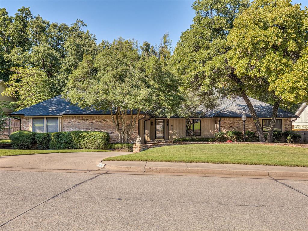 This MUST-SEE home sits on a HALF-ACRE wooded lot with a peaceful creek view and offers a circle driveway with over 3,000 square feet of flexible living space, perfect for MULTI-GENERATIONAL needs! Featuring 4 bedrooms, 3 full bathrooms, and 2 dining areas, this home has room for everyone. 

The living room makes a statement with beamed cathedral ceilings, a striking wood feature wall, and a cozy wood-burning fireplace overlooking the mature trees in the backyard. Just off the living is a wet bar—PERFECT for entertaining—while the kitchen delivers bar seating, a Jenn-Air stove, built-in oven, refrigerator that stays and tons of cabinet space. 

The primary suite is a true retreat with a tray ceiling, brick accent wall, and a Pella sliding door with direct access to the backyard. The skylit en-suite bath includes dual sinks, a walk-in shower, a garden soaker tub, and a MASSIVE walk-in closet. The two generously sized secondary bedrooms share a Jack-and-Jill bathroom, and each features its own large closet. On the opposite side of the home, the fourth bedroom is truly like a SECOND PRIMARY SUITE with its own backyard access, a large walk-in closet, and a full bath right outside the door—offering excellent privacy for guests, in-laws, or extended family. 

Additional highlights include multiple skylights, a cedar closet, solid wood doors, newer roof (2023), HVAC (replaced recently) and water heaters (2025), washer and dryer, plus the bonus of a circle drive and two-car garage. This home truly checks all the boxes. 

Step outside to your new favorite spot—the oversized deck—perfect for grilling, relaxing, and taking in the backdrop of mature trees, flowing creek, and NEW side fencing. This backyard oasis offers plenty of usable yard space along with wooded areas and a peaceful creek, all on a HALF ACRE—making this home truly unforgettable.