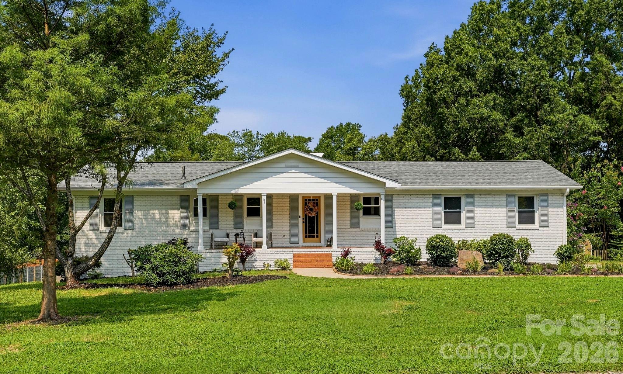 Completely renovated full brick ranch with a walk-out basement in the heart of downtown Cornelius! Situated on over half an acre with no HOA, this stunning 4-bedroom, 3-bath home offers an open-concept floor plan with designer finishes throughout. Recent updates include a new architectural shingle roof, freshly painted brick exterior, new wood and glass front door, upgraded designer lighting and fixtures, and durable LVP and tile flooring throughout—no carpet!! The beautifully redesigned kitchen features quartz countertops, custom white shaker cabinetry with soft-close drawers, a contrasting wood island, upgraded range hood, and premium stainless steel appliances, including a Cosmo commercial-style range and built-in microwave. The spacious main-level primary suite offers a walk-in closet and a luxurious ensuite bath with a custom vanity topped in Taj Mahal quartzite, Delta fixtures, a walk-in shower with oversized 30x60 tile, and slate tile flooring. A stylish secondary full bath on the main level showcases a striking Zellige tile shower. The walk-out basement expands the living space with two additional bedrooms, a full bath, a large bonus/recreation room, and a dedicated laundry room with slate tile flooring—ideal for guests, multi-generational living, or entertaining. Outside, enjoy expansive front and rear yards with fresh landscaping, offering endless possibilities for outdoor living. Conveniently located just minutes from shopping, dining, parks, Lake Norman, and all that downtown Cornelius has to offer, this move-in-ready home combines timeless charm with modern luxury.