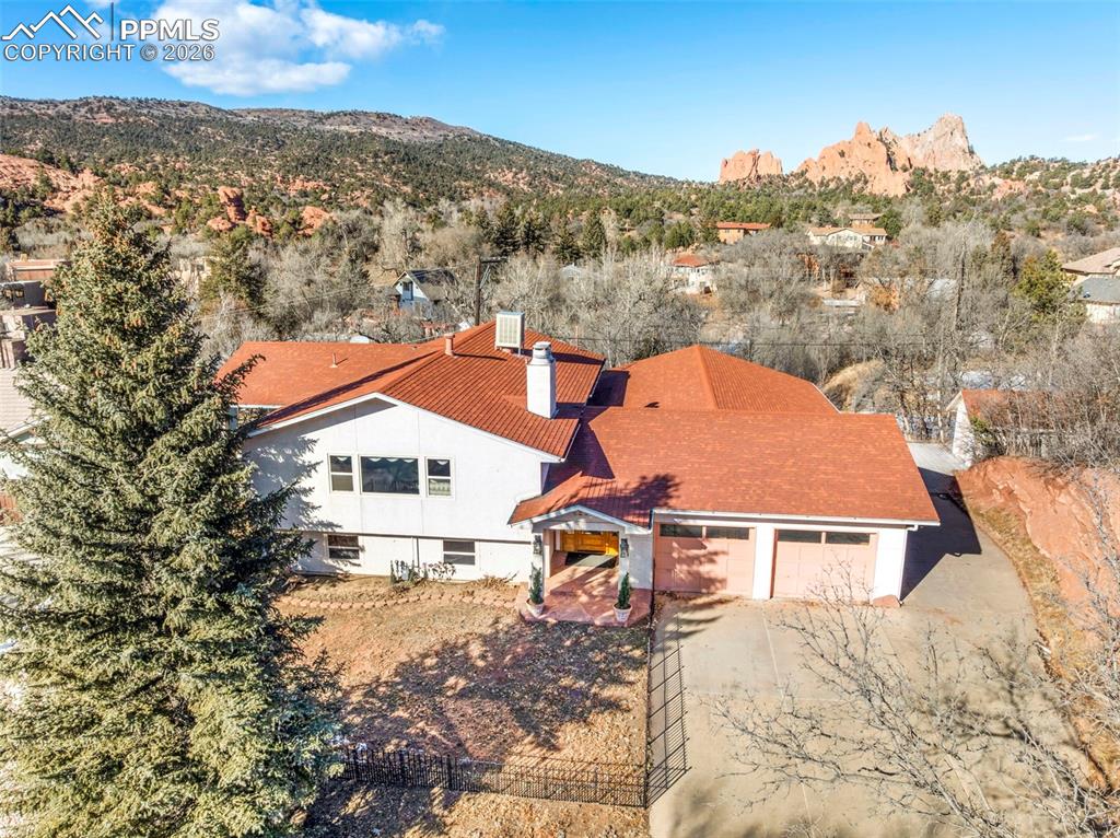 Welcome to a truly rare offering in one of Colorado Springs’ most coveted locations—where unobstructed, jaw-dropping views of the Pikes Peak Mountain Range and the iconic Garden of the Gods, including the legendary Kissing Camels, steal the show from every angle. Perfectly positioned on the Colorado Springs side of the border with Manitou Springs, this home is tucked deep within an extremely sought-after community, offering both privacy and immediate access to nature. Just approximately 100 yards from the property, multiple walking trails lead directly into Garden of the Gods State Park, placing world-class hiking and scenery right outside your door. This 3-bedroom, 2-bathroom home features generously sized rooms designed for comfortable living and effortless entertaining. The spacious kitchen is ideal for meal preparation, boasting abundant counter space and an intuitive layout that flows seamlessly into the main living areas. Perfectly placed windows throughout the home flood the interior with natural light while framing postcard-worthy mountain and red rock views from every room. Step outside to a flat, fully usable yard—an exceptional find in this area—where the scenery is just as breathtaking as it is from inside. The expansive deck is a true highlight, offering a front-row seat to sunrise, sunset, and the ever-changing colors of the mountains and rock formations. A long, very private, south-facing driveway enhances both privacy and year-round usability. Wildlife is a regular and cherished presence, with frequent visits from deer, foxes, eagles, and hawks, and the occasional bear reminding you just how close you are to Colorado’s wild beauty. With unforgettable views from every window, every corner of the yard, and especially from the deck, this home offers a lifestyle that is equal parts serene, scenic, and truly one of a kind. Homes like this—combining location, privacy, trail access, and iconic views—rarely come to market.