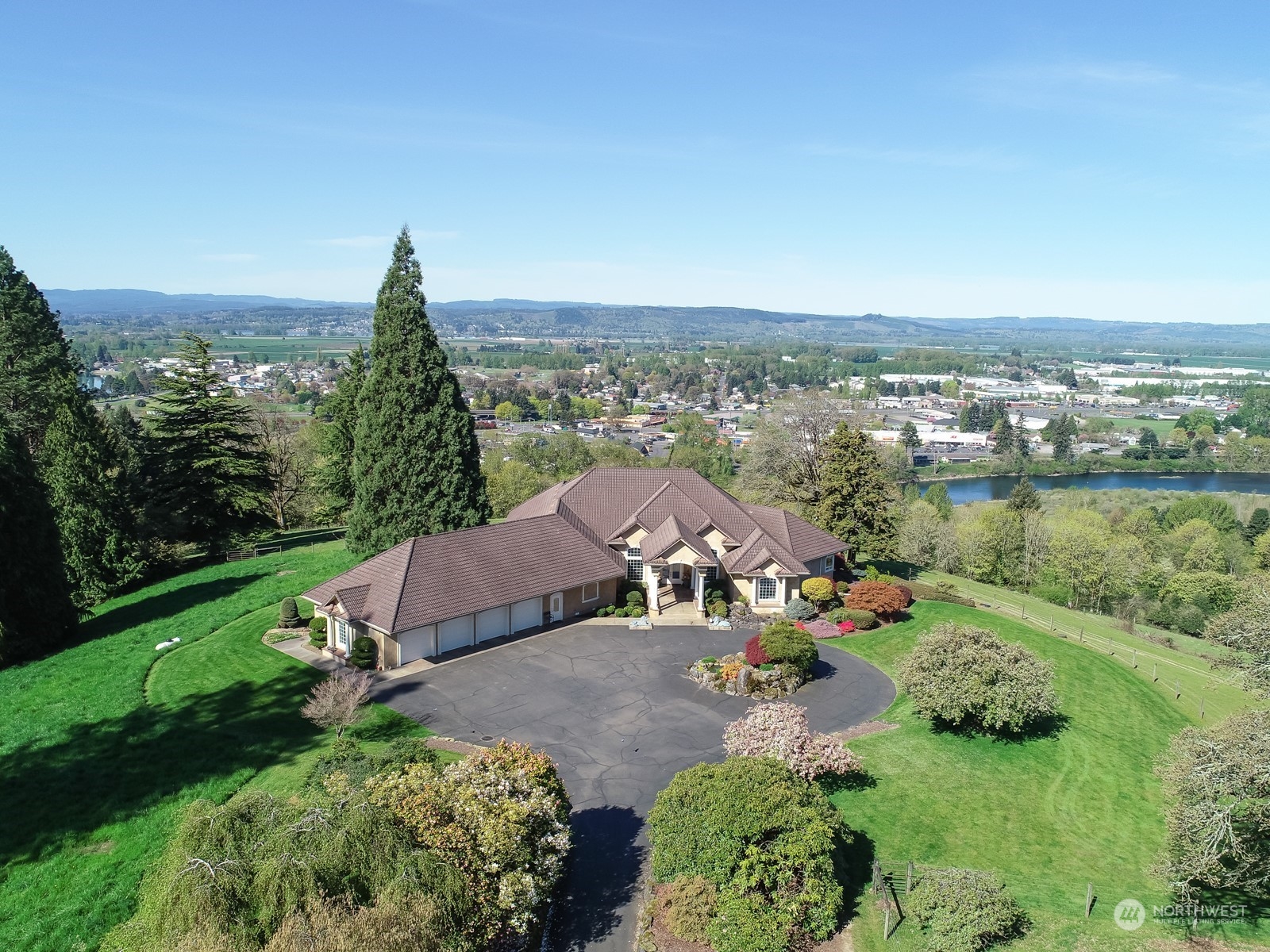 Discover unparalleled luxury & tranquility at this stunning 65-acre river view equestrian estate. Panoramic views of the Columbia River, Lewis River & the Oregon hills. Step into a custom-built, single-level home designed for comfort. The spacious kitchen, equipped with a Sub-Zero refrigerator, double oven & pantry, is perfect for culinary enthusiasts. The en-suite primary bedroom features a gas fireplace & jetted tub. The indoor riding arena is perfect for year-round riding & attached barn features 20 stalls, tack room, hay loft & wash stall. The property also includes a charming three-bedroom guest house & several outbuildings for all your equipment. Potential for development, create additional homesites, additional acreage is available.