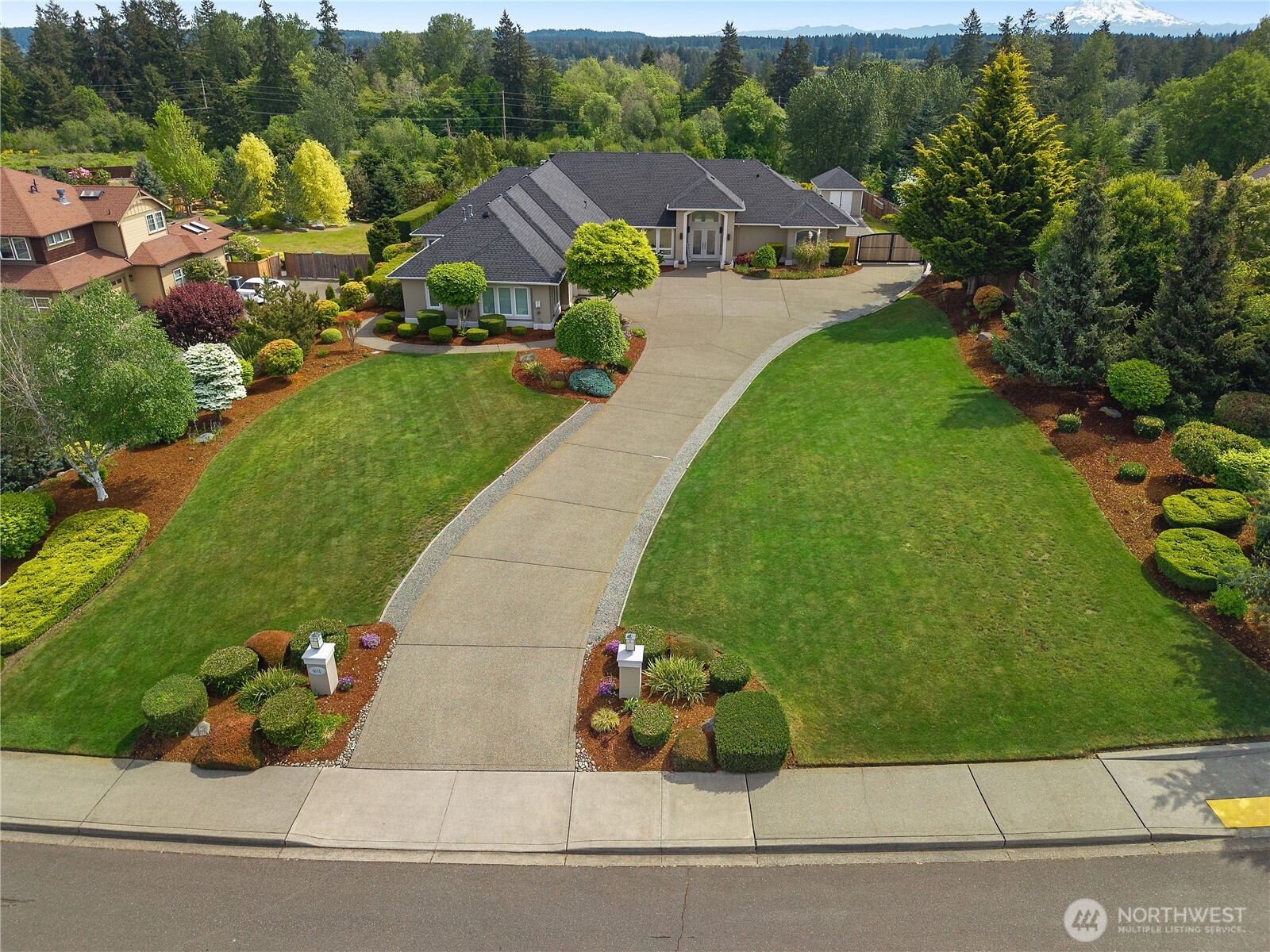 Custom rambler on a beautifully terraced lot with Mt. Rainier views, thoughtful indoor/outdoor living, and exceptional flexibility. This 3,230 SF home includes a finished professional office with 3/4 bath attached to the garage, originally used by the contractor/owner as a private office and ideal for guests, MIL-style space, studio, or work-from-home needs. The high-end, open kitchen is designed for gathering with a huge counter eating area, custom appliances (40" Wolf Range w/griddle and convection/gas oven, double sub-zero) and seamless flow to the main living spaces. The primary suite features a fully customized walk-in closet, deep jetted tub, and comfortable retreat-style layout. Jack and Jill 2nd and 3rd BR, and Den. Outside enjoy the covered patio with fireplace and outdoor BBQ kitchenette (Patio with built-in sink and 2 overhead heaters), perfect for year-round entertaining. The attached 3-car finished garage includes shop space, whole house generator, plus RV parking tucked behind the fence. A rare blend of custom craftsmanship, usable space, and Northwest lifestyle amenities in a great Lacey location. Well maintained - Ext Paint 2023, New 40 year Roof 2023, Gas Water Heater 2026. Call your Broker TODAY!
