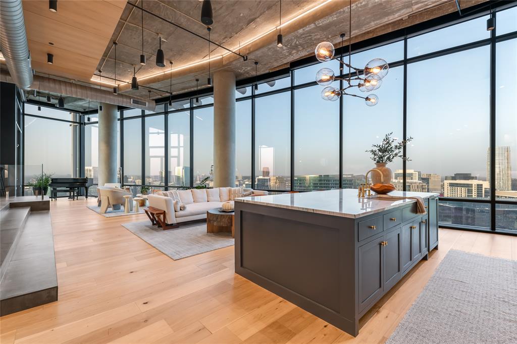 Experience a new definition of luxury in the sky, located on the 32nd floor, the tallest in all the W residences. Completely redone with brand new finishes this one-of-a-kind penthouse offers breathtaking views throughout with floor-to-ceiling windows complemented with both east and west patios. Featuring top-tier finishes, roman plaster textured walls, welcomed with  Lutron lighting that casts a soft, welcoming glow perfect for setting the mood for entertaining guests. The expansive open concept of living and dining areas flow seamlessly into a stunning chef’s kitchen, leading to a one-of-a-kind home bar with commercial features. Equipped with a Hoshizaki pebble ice maker, a Miele glassware dishwasher, a wine cooler, and a Toki highball machine found exclusively in top bars worldwide, chills whisky and soda to perfection, preventing dilution while delivering five times the carbonation of regular soda water. Architectural elements elevate the design, enhancing the dramatic city views throughout. The primary suite greets you with a cozy seating area and a see-through gas fireplace, creating both warmth and a sense of separation from the spacious bedroom. The adjoining bath features a luxurious double primary shower being led to a large walk-in closet. Designed for ultimate entertainment, the penthouse features five zones of Sonos speakers, including built-in subwoofers, for an immersive audio experience. In addition to hotel-style amenities including room service this is a prime location, with a newly renovated lobby coming soon. This penthouse offers a sophisticated retreat in the heart of the city, combining convenience, style, and world-class amenities for those seeking a home in the sky.