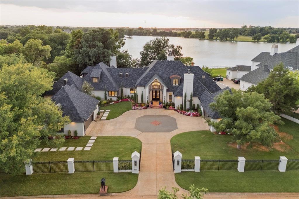 Welcome to 18909 Saddle River - This re imagined 5-bedroom estate with private study is perfectly positioned to capture picturesque lake views on one of Mulholland’s most desired lots. Designed for both grand entertaining and effortless everyday living, the expansive backyard unfolds into a secluded oasis featuring an infinity-edge pool with water slide, an inviting spa, a fully appointed cabana, and a dramatic outdoor fireplace all embraced by lush landscaping and tranquil water vistas. The thoughtful floorplan offers true multi generational living, with the primary suite nestled on one wing and a full mother-in-law suite on the opposite side of the home. Adjacent to the guest quarters, a dedicated fitness studio or flex room provides versatile functionality. At the heart of the home, the fully reimagined designer kitchen showcases top-tier appliances, bespoke cabinetry, an oversized statement island, designer lighting, and an expansive walk-in pantry. An entertainer’s dream and a culinary masterpiece in its own right. The primary suite offers a retreat of pure sophistication. A cozy fireplace and handpainted De Gournay wallpaper create an atmosphere of elegance, while the custom closet impresses with a fingerprint-entry safe, and built-in washer and dryer. The spa-inspired bathroom features a soaking tub, oversized walk-in shower, heated marble floors, dual vanities, a dedicated makeup space, and luxe fixtures. Upstairs, three spacious en suite bedrooms connect through the main staircase, while a second, private staircase leads to a secluded theatre room with its own full bath.  Perfect for movie nights, gaming, or additional guest accommodations. The detached cabana elevates outdoor living with its full bathroom, kitchenette, and Murphy bed, creating an ideal haven for extended guests or luxurious poolside lounging. This exceptional property blends architectural beauty with modern comfort, delivering a lifestyle of timeless luxury and effortless refinement.