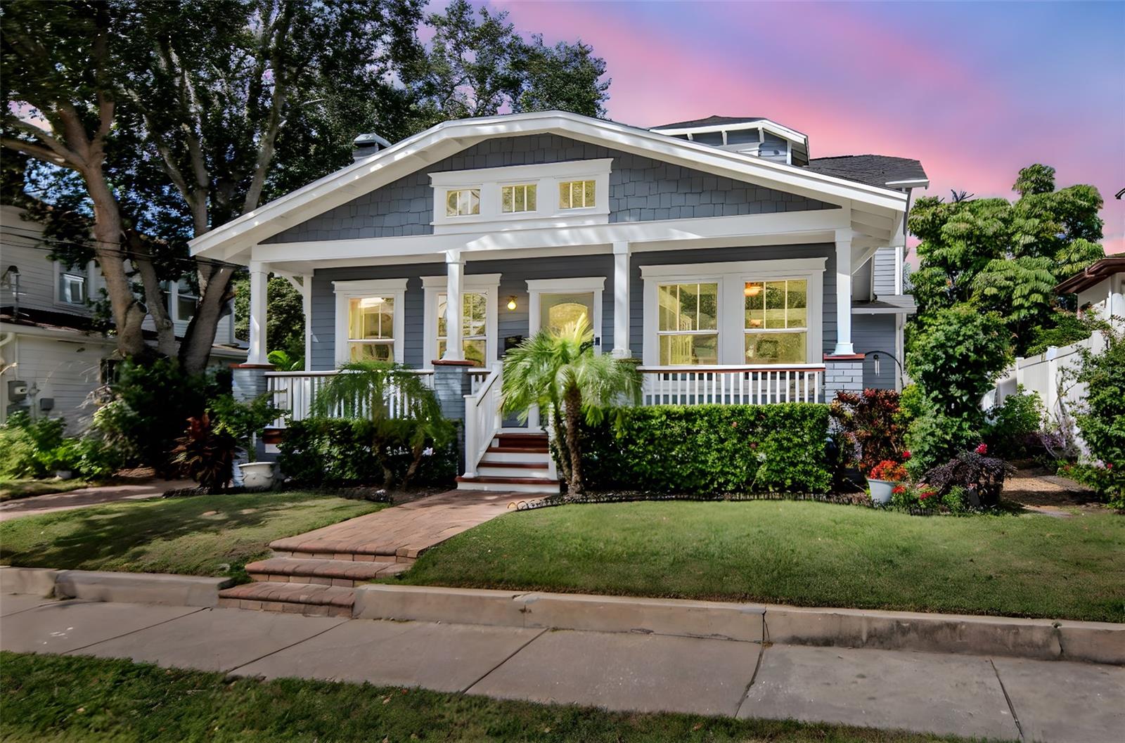 Step into a perfect blend of South Tampa charm and contemporary refinement.  From the inviting front porch of this Craftsman-inspired home—with its strong horizontal profile, tapered brick piers, “bungalow meets modern addition” feel—you immediately sense a graceful balance of heritage and upgrade. The covered porch welcomes guests into the heart of this residence.
On the inside, the main level opens with wide oak plank flooring, 9-foot ceilings, and a natural light stream through tall windows. A formal living room anchors the home with a stylish wood-burning fireplace and custom mantle, while adjacent you’ll find a sunroom filled with light  and a formal dining area ideal for entertaining. The kitchen was designed with thoughtfulness and style: a center island/breakfast bar, stainless-steel appliances (including an induction cooktop and built-in convection oven), and beautiful granite countertops. The kitchen flows directly into a family room that opens to the backyard patio, creating a seamless indoor/outdoor zone perfect for daily living or hosting guests.
The owner’s suite is located on the main floor and delivers both comfort and elegance: dual vanities, a pedestal free standing tub, and a separate glass-enclosed shower.  A flexible office/den just off the main level can serve as a guest room, home office or secondary living space. A quaint powder bath is conveniently located adjacent to the study.  Upstairs, a well-lit secondary primary suite sits alongside two additional bedrooms, a full bathroom and a convenient upstairs laundry room — creating a thoughtful layout for family or visiting guests.
Through every space, architectural details shine: crown molding, wood casings and built-ins honor the earlier bungalow character while the scale of the addition (added in 2017 to the original 1300 sqft bungalow) holds its own for modern life. With approx. 3,224 sq ft of living space, this two-level residence delivers both formal and casual zones, private and shared spaces, and a timeless palette of finishes.
Outside, you’ll find a backyard sanctuary designed for both activity and relaxation. A contemporary lap pool (added in 2018) offers a clean, long swim lane and crisp resort-like edges. French doors from the family room open the house to the outdoors, reinforcing the sense of continuous living. The result is a fully fenced-in backyard retreat tailored to lifestyle. Mature landscaping and a low-maintenance lawn border the space, providing privacy and a lush backdrop. 
Parking and garage access are handled with the same notion of thoughtful design: there is a detached one-car garage, accessed via a long driveway and granting a separate side entry to the kitchen area for everyday ease. An electric vehicle charger is conveniently located nearby and conveys with the home.  
This home is truly a rare find—melding South Tampa’s street-charm, walkability, bay-close lifestyle, and contemporary amenities. From the welcoming front porch to the refreshed interior and the pool-side retreat, every detail has been sculpted for style, comfort and function. The Sellers are including a 1 year American Home Shield Warranty. You don't want to miss this one!! Call for your private showing.