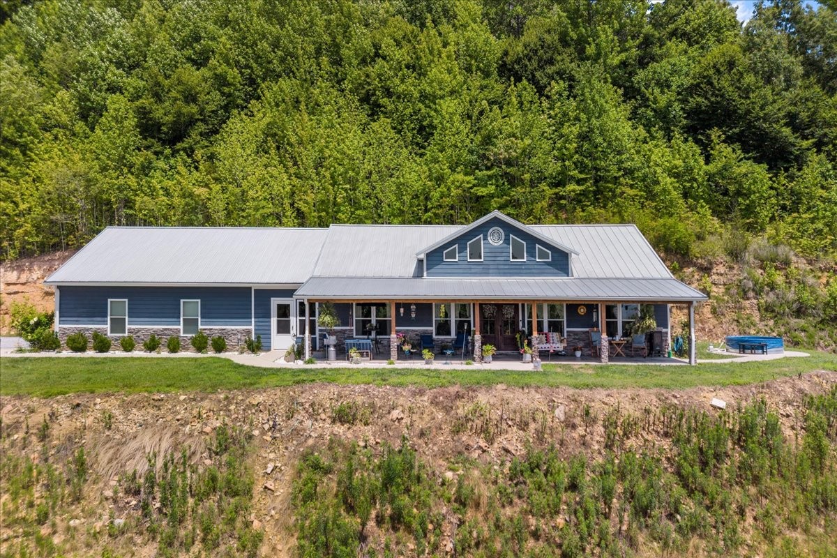 Stunning Secluded Kentucky Lake Waterfront Retreat in Middle Tennessee! Seller offering $15,000 for new flooring.Escape to your own private paradise with this breathtaking 3 bedroom, 2 bath waterfront home offering 2212 square feet of beautifully crafted living space on the Tennessee River/Kentucky Lake.  Tucked away at the end of a quiet dead-end road with no neighbors in sight, this rare property combines luxury, privacy and the beauty of nature.Enjoy approximately 300 feet of waterfront access complete with a floating dock, perfect for boating, fishing, or relaxing on the water.  Watch bald eagles soar overhead while deer roam through the peaceful landscape.Built with quality and efficiency in mind, this home features durable hardboard siding, a standing seam metal roof, spray foam insulation, and a 400 amp electrical service.  Inside, you'll find quartz countertops, custom cabinetry, spacious living areas, and an enclosed heated breezeway connecting the home to the attached 2-car garage.Outdoor living is unmatched with a full length porch ideal for taking in the stunning lake views and the quiet surroundings. Additional features includes a Generac generator, storm shelter, and an extra lot included with the property for added privacy or future possibilities.If you've been searching for the ultimate private waterfront retreat in Middle Tennessee, this one-of-a-kind property delivers unmatched peace, comfort, and lakefront living!