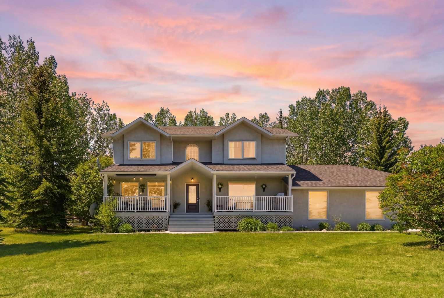 PRICE IMPROVEMENT!!!  Prestigious Springbank acreage living on a private 4-acre parcel in one of the area's most sought-after locations. Ideally situated just minutes from Calgary, Cochrane, and the growing Bingham Crossing commercial development, this exceptional property offers quick and convenient access to downtown Calgary, Stoney Trail, and the Trans-Canada Highway for an easy commute to Banff and the Rocky Mountains.The extensively updated two-storey home offers 2,270 sq. ft. of bright, functional living space with 4 bedrooms and 2.5 bathrooms. The renovated kitchen features quartz countertops, stainless steel appliances, and abundant natural light, while spacious living areas provide plenty of room for family living and entertaining. A large rear deck overlooks the acreage, creating the perfect setting to enjoy the privacy and tranquility of country living. The fully developed basement adds additional living space and a fourth bedroom. Additional features include in-floor heating, a triple attached garage, upgraded mechanical systems, central vacuum, air exchanger, and a new water filtration system with water collection tanks.A major highlight of the property is the heated commercial-grade shop offering over 2,800 sq. ft. of versatile workspace. Featuring 13.5-foot ceilings, a 12-foot overhead door, 3-phase power with a 42 kW transformer, in-floor heating throughout, excellent access, and apractical layout with dedicated work and storage areas, the shop is ideally suited for trades, fabrication, automotive use, equipmentstorage, or a home-based business. The shop also offers excellent income potential, with comparable space in the area capable of generating solid rental earning potential.Adding even greater value, the 4-acre parcel offers subdivision potential, subject to municipality approval and buyer verification, providing future owners with flexibility and additional possibilities.Rarely does a property offer a renovated family home, triple attached garage, commercial-grade shop, acreage living, income potential, and subdivision potential in one exceptional package. Located near highly regarded Springbank schools and offering convenient access to Calgary, Cochrane, major transportation routes, and the mountains, this is a unique opportunity to live, work, and invest in one of Springbank's most desirable communities.