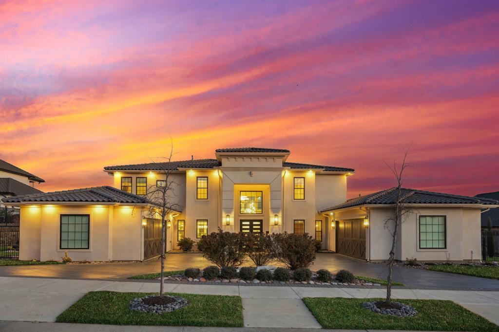 Open Sat. March 7, 12-3; Sunday March 8, 2-4. Modern 2020 custom built stucco almost 6,000 SF luxury 4 bedroom, 5.5 bath (with HOA approved addition plans for a Junior suite 5th bedroom) luxury estate home spanning across a golf course view and half an acre in guard-gated master planned Enchanted Hills. The first floor flows into large spacious living and dining filled with natural light and views of the rolling vistas of the lakes at castle hills, with endless entertaining and gathering space. The Owners ensuite Spa bath features a sitting room, a spa bath, spacious walk in closet with custom built ins.  Watch movies in the first floor media room. Study, plus two mudrooms convenient to the 4 car garage.  ADU with 10X 10 room & full bath. Notable architectural details include two story soaring ceilings, floor to ceiling fireplace, two kitchens, ensuite baths in each bedroom & a half bath close to the media room. The expansive kitchen offers a wide, nearly 16' long island, Thermador built in coffeemaker, fridge, oven, microwave added in Jan. 2026. Six-burner Thermador gas cooktop, two dishwashers, white modern European cabinetry with self close cabinets and deep drawers providing an abundance of kitchen and second kitchen storage, a beautiful chandelier, a prep kitchen with an appliance pantry, second oven, sink, fridge, abundance of cabinetry, additional oven & sink.  The second floor features open to first floor views, each bedroom offers its own en-suite bath. Junior Suite bedroom offers a private balcony with golf views, Game Room with sink & bar has a balcony extending entertaining covered outdoor space viewing stunning golf course & pond views. Large outdoor kitchen, narrow, grill, fire pit, living and seating to entertain friends in the spacious yard with iron fence. Castle Hills is a master planned community. Enjoy front-row fireworks & the convenience of being minutes to Legacy West, Frisco, DFW Airport, 121, I-35, Tollway, grocery, dining, shopping.