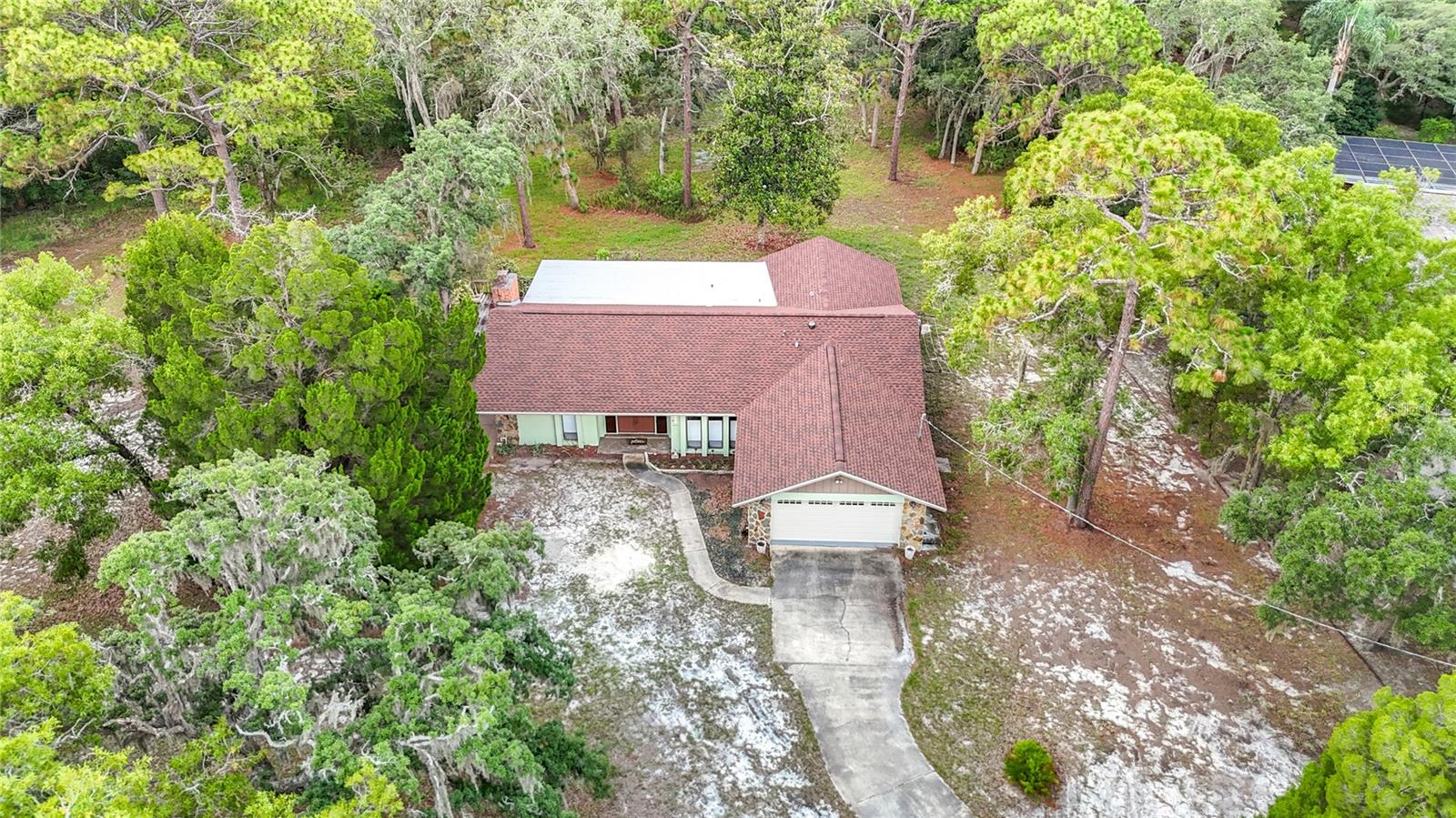 Tucked away on a rare 1.12-acre homesite with peaceful surroundings, this spacious home offers endless potential. Clean, well maintained, and full of character, it's ready for your personal updates and vision. Enjoy generous living spaces, a large screened lanai, and the privacy of a park-like setting while still being conveniently located near shopping, dining, and everyday amenities. Opportunities like this are becoming increasingly hard to find. Bring your ideas and make this one your own!