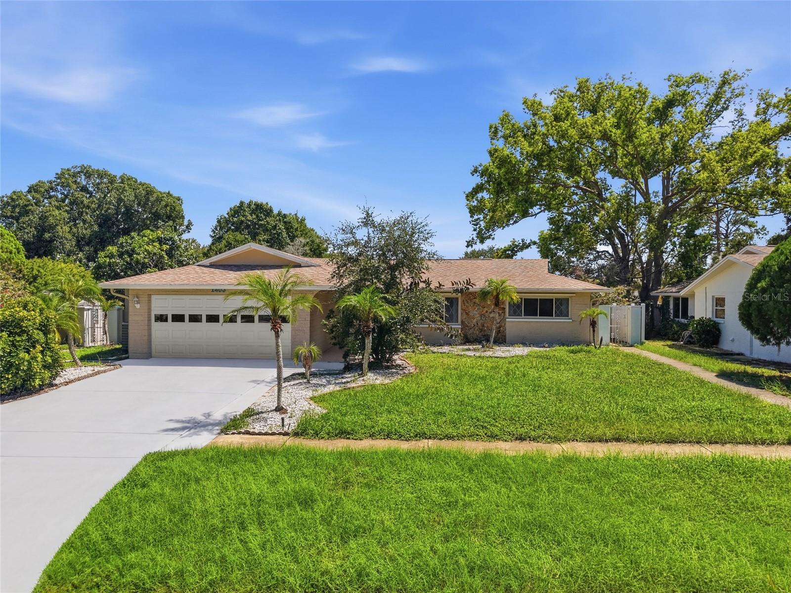 Coastal living meets incredible flexibility in this beautifully updated pool home with a separate guest house, located less than a mile from Sunset Beach and just minutes from the Sponge Docks and downtown Tarpon Springs. Set on a spacious 1/4-acre corner lot, the main home features 3 bedrooms, 2 fully remodeled bathrooms (2022), an open and airy layout, an oversized two car garage, and a new roof installed in (2020). The private backyard oasis offers a heated saltwater pool, brick paver patio, covered outdoor living space, and a gated side yard ideal for RV or boat parking. This home has a detached guest house, perfect for coastal vacation rentals, multigenerational living, or extended stay guests. The separate residence includes 2-bedrooms, 1-bathroom, private entrances from both side yard and pool area, and a brand-new AC unit installed in (2025). Additional upgrades include a new pool pump and heater (2022). This home may be sold fully furnished, offering a turnkey opportunity for immediate move-in or rental use.