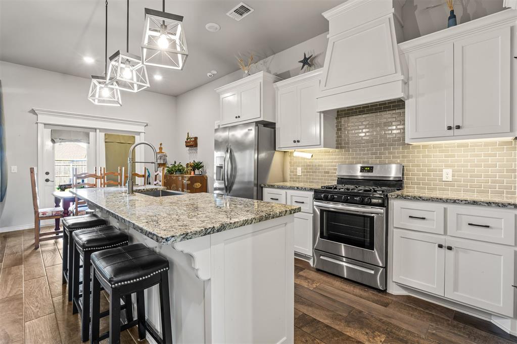 Plant your roots in Park Place Heights, one of Mustang’s newest communities, perfectly located for convenience and easy living! 1,650 sq. ft. of interior living space and 115 sq. ft. of outdoor living space. Featuring 4 bedrooms, 2 bathrooms, and a 2-car garage with an installed storm shelter, this home has everything you need and more. The spacious living room features a stunning stacked-stone corner fireplace, large windows that bring in plenty of natural light, and an open-concept layout that flows seamlessly into the kitchen. The kitchen offers granite countertops, a stylish backsplash, pendant lighting, and a large corner pantry, making it both beautiful and functional. The private primary suite is tucked away from the additional bedrooms, creating a quiet space to relax and unwind. The primary bedroom features a beautiful box ceiling detail and connects to a spacious bathroom with a Jetta tub, walk-in shower, and oversized walk-in closet. Step outside to your covered outdoor living space, complete with an outdoor fireplace, gas line hookup, and cable outlet. The fully fenced backyard is perfect for enjoying the Oklahoma outdoors or entertaining friends and family. This home also comes packed with energy-efficient and smart-home features, including Tabertech Smart Home technology, a whole-home air filtration system, a tankless water heater, R-44 insulation, and a TechShield radiant barrier designed to improve energy efficiency and comfort. With its thoughtful layout, upgraded features, and fantastic outdoor living space, the Hunter floor plan at Park Place Heights is a home you won’t want to miss!