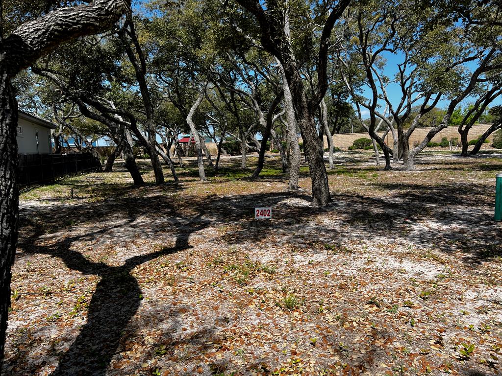 See what is behind the gate at Royal Oaks! The name says it all with majestic oak trees blanketing each lot. Only limited to one's imagination, this 6655 sq.ft. lot is ready for your custom build to commence. This exclusive gated waterfront community provides the pleasure of privacy with the storybook elegantly curved walls that line the front and back of the community. Entering the neighborhood over the cobble stone road from Fulton Beach Rd, past the guardhouse, immediately a rush of calm takes over. This therapeutic setting will be your place of peace and easy living. Take a minute to stroll the lighted walk paths to the gorgeous pool or gather under the gazebo. Invite friends for an evening around the fire pit to talk about the day on the boat while sipping on your favorite beverage. Need a little putting practice? Pick from the two greens overlooking the bay. Morning, afternoon or evening, the lighted fishing pier is the perfect place to drop a line.