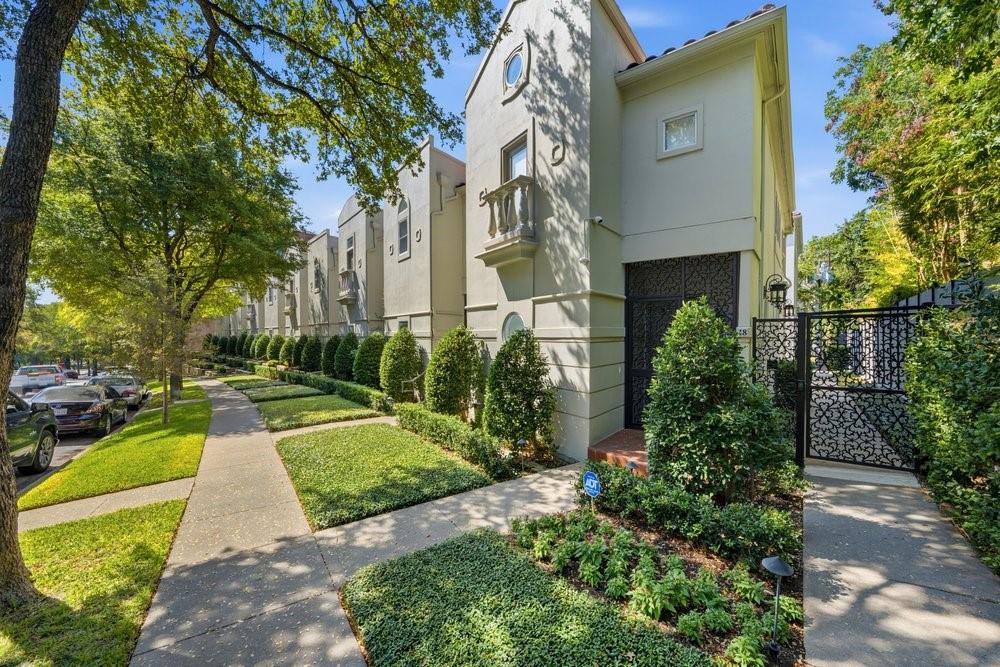 Tucked beneath a canopy of mature trees on one of Turtle Creek’s most charming residential blocks, this beautifully updated three-story corner condo feels wonderfully private and removed from the city—while placing some of Dallas’ best parks, trails, dining and nightlife just outside your door.Warm, inviting and full of character throughout, the home has a wonderful sense of charm and privacy across all three levels. On the main floor, a large, updated kitchen with stainless steel appliances overlooks the spacious living area, where a beautiful fireplace creates a natural focal point. From there, doors open to a private, shaded and turfed backyard—an unexpected outdoor retreat perfect for morning coffee, entertaining friends or unwinding at the end of the day. The second-floor primary suite is a true escape, complete with a charming Juliet balcony and a spacious ensuite bath featuring a jetted tub and separate walk-in shower. An exceptionally large walk-in closet with an extensive custom organization system offers incredible storage and makes keeping everything in its place effortless. Upstairs, the third floor offers two additional bedrooms with a shared bath, while each bedroom enjoys its own private vanity. One opens to another Juliet balcony overlooking the community’s Spanish-tile rooftops—a picturesque view that feels more like a hidden European courtyard than the heart of Dallas. The home also features updated HVAC, a private parking garage with two dedicated spaces and a separate storage unit, plus ample street parking for guests. Beautiful Turtle Creek Park and the Katy Trail are just a short walk away, along with the restaurants, cafés, shopping and nightlife of Oak Lawn and Uptown. It’s a rare combination: genuinely walkable city living with the quiet, shaded and secluded feeling of a residential retreat. Updated, private and undeniably charming, this is Turtle Creek living at its best.
