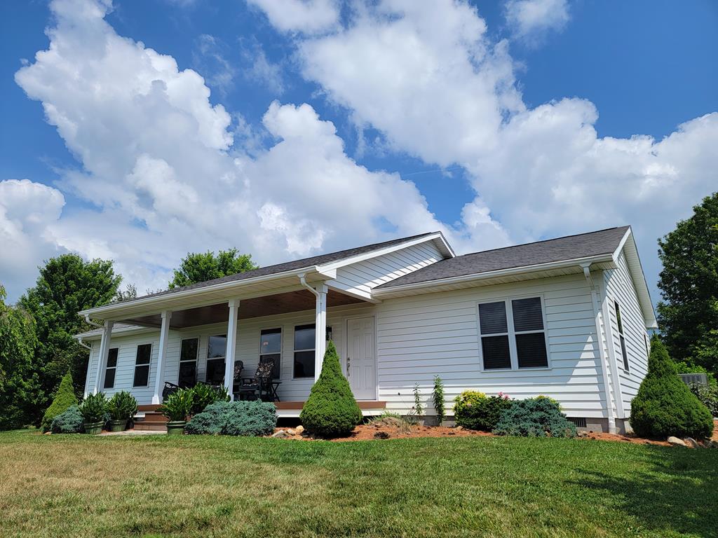 Experience exceptional living in this immaculate, one level home featuring three bedrooms and two bathrooms in the Elk Creek community. The meticulously maintained yard boasts pristine landscaping and a secure fence—ideal for pets or added privacy. There's also a vinyl sided workshop/storage building for all your outdoor needs. Enjoy a beautiful view from the front porch of Elk Creek valley and Point Lookout mountain with durable composite decking on the front porch, perfect for relaxing and taking in breathtaking mountain views. Inside, the home offers elegant flooring, updated kitchen and bathrooms, and an ample laundry area. All of this is set on 3.2 beautifully landscaped acres, highlighted by a tree-lined driveway.  This is truly a move in ready property that feels like home as soon as you walk in.   So many details the owner thought about while building this house.   The grounds are truly amazing.  Come take a look today!
