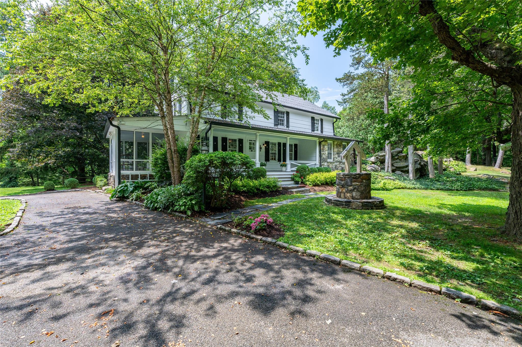 Nestled in the heart of Armonk sits 69 Whippoorwill Rd, a timeless 1790 antique gem set on 1.4 lush green acres. Brimming with historic character and modern comforts, the main home is a beautifully preserved 3-bedroom abode that lives like a 5-bedroom with unmatched charm throughout - original doors, wide plank floors, and hand-hewn exposed wooden beams honor the home’s rich heritage. The first floor offers seamless transition between the kitchen, living area and dining room with an attached screened-in porch perfect for enjoying afternoon tea and a summer's breeze. A bedroom with full bath off the kitchen provides a bonus space perfect for a guest room and/or home office. Upstairs you'll find a primary suite with a fully renovated bath and access to the finished 3rd floor.  Additionally, a generously sized 2nd bedroom, fully renovated hall bath and sunny sitting room complete this floor. The detached garage which encompasses the historic charm of what once was the chauffeur's quarters from its original build includes a fully finished guest cottage with its own full bath—perfect for visitors, a home office, or creative retreat. This gorgeously landscaped property dotted with specimen trees and curated plantings borders the Fordham University Louis Calder Center, offering panoramic tranquility and land that gently slopes toward Calder Lake. Whether sipping coffee on the porch, relaxing on the tree swing or exploring the nature trails just beyond your backyard, this is a property that invites serenity and inspiration. A must-see Whippoorwill classic.