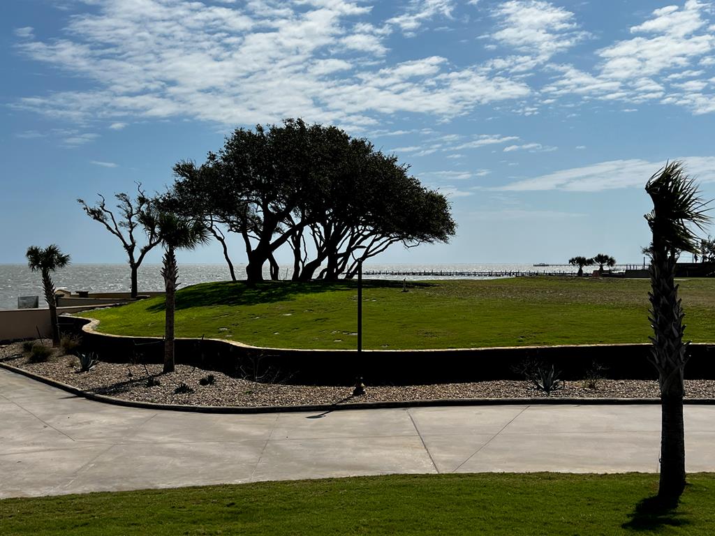 It's time to own your own exclusive inner sanctum in Royal Oaks! Build your custom exceptional waterfront estate on this oversized lot with 180 degree view of Aransas Bay. Wake to the endless sunrises glistening over the Aransas Bay and sweet sounds of the water from this 21,312 sq.ft. lot. Royal Oaks is a world unto itself umbrellaed with enchanted windswept Oak trees, sprinkled with sitting areas, walking trails lit with quaint light posts. The tastefully designed neighborhood is gated with easy access to highway 35 and its main entrance fronting Fulton Beach Rd. The cobble stone entrance with guard house meets with the storybook curved stucco and stone privacy fence lining the front and back of the development providing next level privacy. Molded for prestigious living, you will adore the amenities including the two putting greens, stone gazebo with brick fire pit and lighted pier with fish cleaning station.