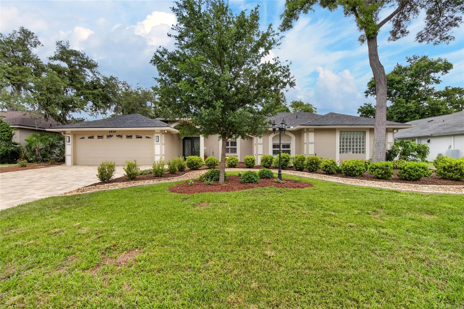 Welcome to your Dream Home in the coveted Walden Lake Community in Plant City. This immaculate 4-Bedroom, 3-Bath Residence offers over 2,500 square feet of Heated Living Space and a Spacious 2-Car Garage. An Open Floor Plan with Soaring High Ceilings Greets you, while multiple sliding doors create a seamless flow to the Spectacular Screened Lanai. The Heated Pool and Spa were beautifully Resurfaced and Paved in 2024, surrounded by a new Paver Walkway and Driveway leading up to the Front of the Home. The Large Kitchen is a Chef’s Delight, Featuring Sleek Black Appliances, Abundant Cabinetry, and Generous Countertop Space, including a Breakfast Bar with seating. The Kitchen opens up to a Family Room and Dinette all overlooking the Pool Oasis. The Family room is a warm and inviting Space, anchored by a Cozy Fireplace and Enhanced by Elegant Tray Ceilings adding a touch of Sophistication. Entertain with Ease in Both a Formal Living and Dining Room, while the Split Floor Plan offers Privacy with Generously Sized Bedrooms. On one side, Two Spacious Bedrooms share a well-appointed Bathroom. On the Opposite Side, the Luxurious Primary Suite awaits, with its Own Private Sliders to the Lanai, Two Walk-in Closets and a Spa-like ensuite with Dual Vanities, a Garden Tub and a Seperate Shower.  Additionally, a Fourth Bedroom on this side offers flexibility as a Guest Room or Office, with access to the Third Bathroom both inside the Home and to the Pool. Upgrades include a New Roof (2024), a Water Heater (2020), Water Softner System (2022) and a Pool Heater and Pump (2024). Impeccably landscaped, with no carpet, this home is truly move-in ready, and the affordable HOA has no CDD fees. Don’t miss out on this pristine, turnkey gem!