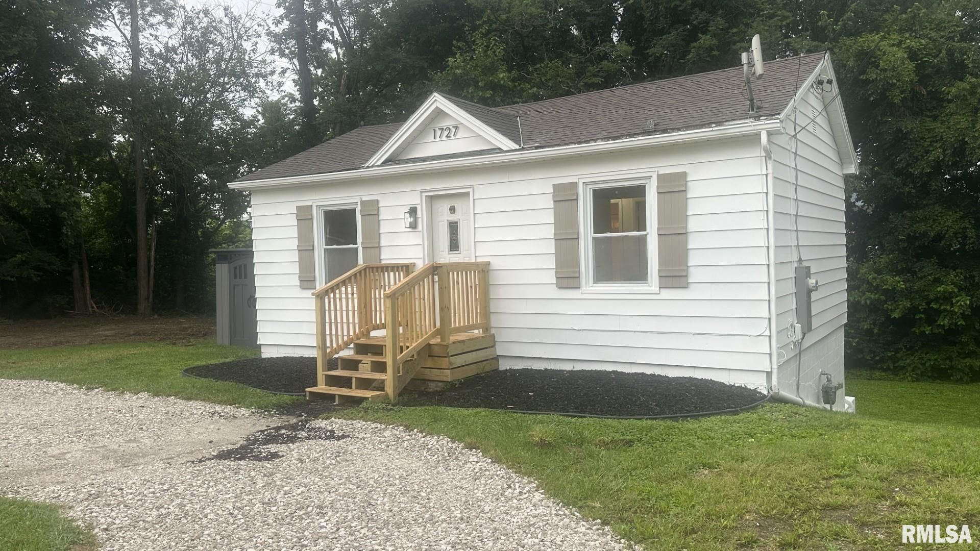 Cute, cozy, and much bigger than it looks! In addition to the main floor, you'll find over 500 finished square feet in the walk-out basement, creating excellent extra living space for a family room, home office, recreation area, or guests.  The updated kitchen features 2026 cabinets, dishwasher, and plumbing, while additional 2026 improvements include flooring throughout, fresh paint, bathroom vanity, tub surround, a 100-amp breaker panel, and GFCI outlets. Most windows have been replaced with vinyl windows, with only two basement windows remaining original.  Situated on three lots totaling approximately 0.40 acres per legal description, this oversized corner lot offers plenty of room to enjoy. A recently installed gravel circle driveway provides abundant off-street parking and easy access.  Conveniently located just one block north of Locust Street, this move-in ready home offers updated finishes, additional finished living space, and a rare oversized lot. Don't let the charming exterior fool you—there's far more room inside than meets the eye!  Agent Owned.