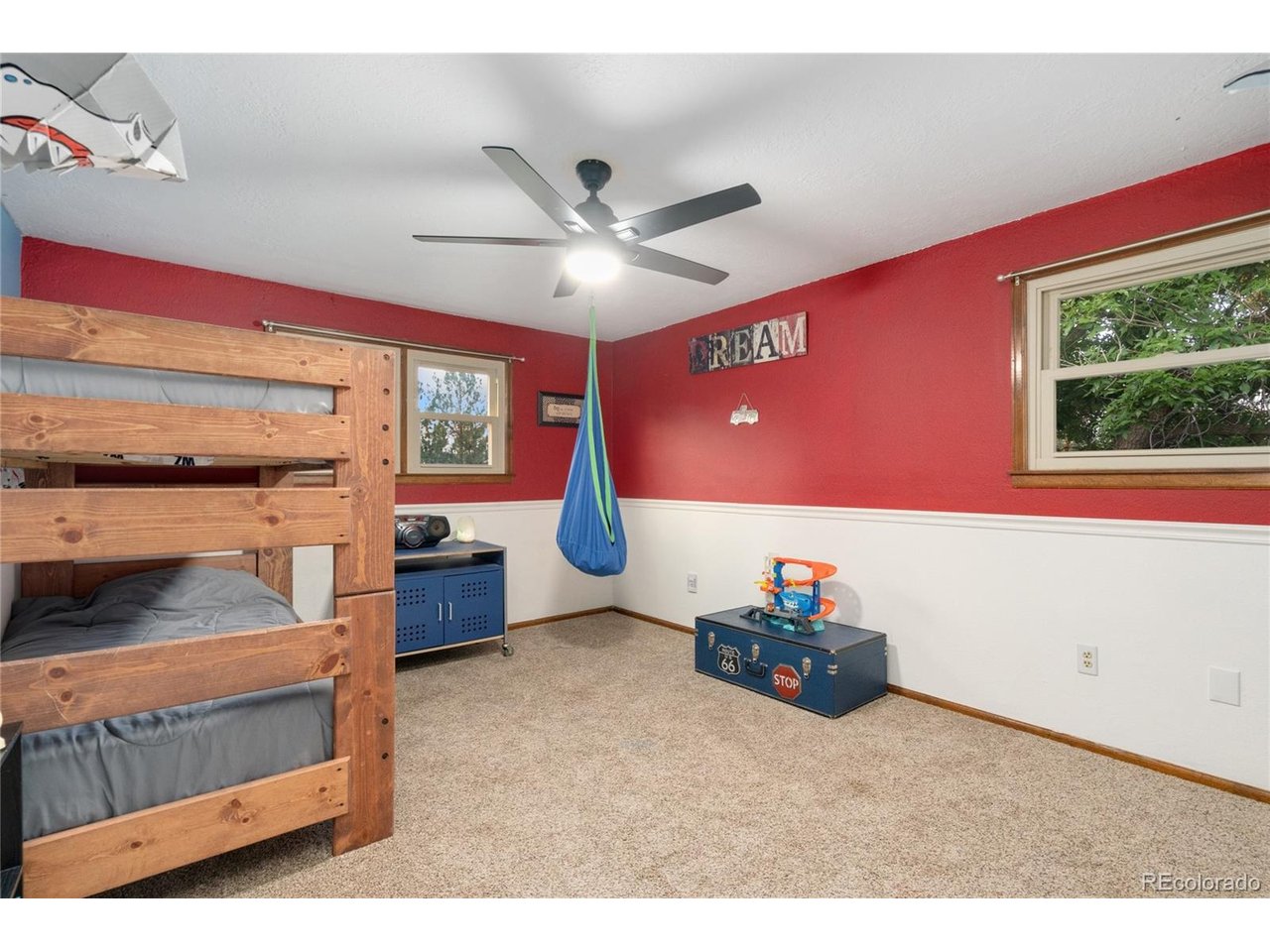 Don't miss this rare opportunity to enjoy country living with the convenience of the city just minutes away. Tucked in 1.68 acres at the edge of Loveland, this beautifully updated 3-bedroom, 2-bathroom two story offers space to breathe, room to grow, and endless potential. Step inside to discover thoughtful updates throughout, a warm and welcoming layout with laminate flooring, updated bathrooms, two living rooms, a dedicated dining room, and a spacious laundry room that adds both function and charm. The huge private deck off of the master creates an outdoor sanctuary ideal for morning coffee or a nightcap! The property shines with tons of mature trees, a cozy firepit area perfect for gatherings under the stars, and plenty of room for horses, chickens, goats, or hobbies. Harvest your haul from the apple and chokecherry trees, grapevines, gooseberry bushes, and rhubarb plants. The home has an attached two car garage as well as two half-circle driveways, making coming and going a breeze, whether you're hauling a trailer, welcoming guests, or parking extra vehicles. The detached 800 sq ft shop, complete with electricity, is ideal for projects, storage, or creative ventures, while an additional outbuilding includes a pool table for fun-filled evenings. With no HOA, the freedom to truly make this property your own is yours. All new windows (2024), new roof on all buildings (2024), newer furnace and A/C, newer interior and exterior paint, and new ceiling fans, tankless water heater (2018), and new smoke detectors! Whether you're seeking a peaceful retreat, space for animals, or simply a place that offers both privacy and connection, this Loveland gem is ready to welcome you home.