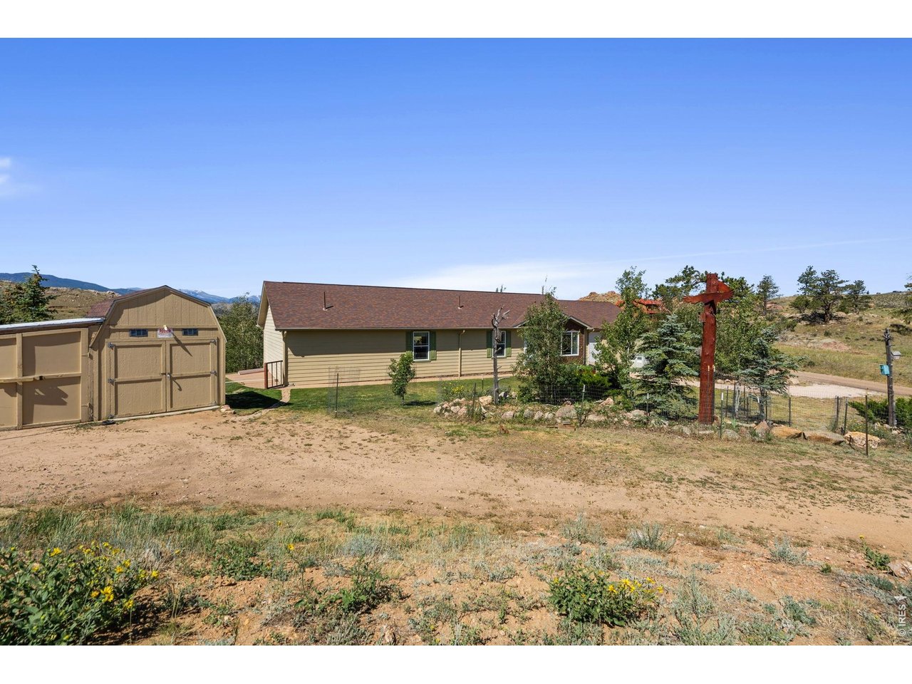 This single-level home in Glacier View Meadows offers breathtaking views of surrounding peaks and endless skies, creating a mountain setting that truly feels like heaven on earth! Situated on a 2.40-acre corner lot, the property provides ample room for outdoor entertaining, gardening, and enjoying the peaceful surroundings. Inside, you are welcomed by a comfortable layout boasting an easy, natural flow. The home features three bedrooms and two living areas, thoughtfully connected for both everyday living and flexibility. The kitchen showcases modern stainless steel appliances, a center island, and generous prep room designed to keep every cooking essential within arm's reach. The primary suite serves as a quiet retreat, including a private ensuite bathroom and a walk-in closet. The secondary bedrooms share a convenient Jack-and-Jill bath. Outside, a stamped concrete patio with an included hot tub creates the ultimate venue to relax and take in the panoramic mountain views, with frequent wildlife sightings adding to the experience. For hobbies and toys, the massive 900sqft detached garage has two separate doors and provides plenty of room for vehicle parking, gear storage, and outdoor equipment. The Glacier View Meadows community is bordered by national forest land and features three private lakes, offering residents premier access to hiking, hunting, fishing, and exploring. Peaceful yet accessible, you are only approximately 45 minutes from Fort Collins!
