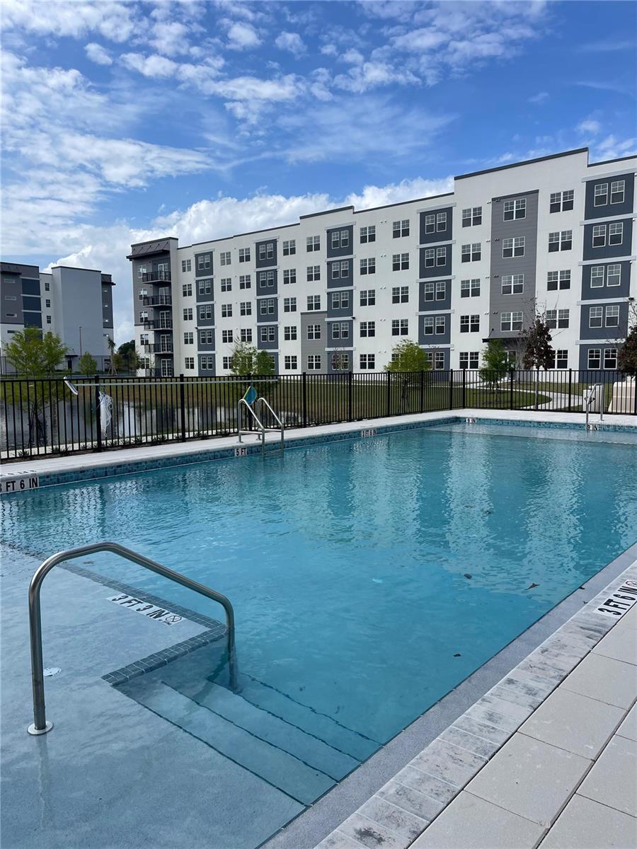 Brand-new 1-bedroom + den, 1-bathroom condo with WATER VIEWS, located in the desirable Millenia Park community. This unit features a bright and open layout with modern finishes and abundant natural light, enhanced by serene views of the water that create a peaceful living environment. The contemporary kitchen offers stainless steel appliances, granite countertops, and ample cabinet space, flowing seamlessly into the living and dining areas. The spacious den provides a versatile area ideal for a home office, additional living space, or guest area.The primary bedroom is well-sized and complemented by a modern bathroom. Additional highlights include 9-foot ceilings and an in-unit washer and dryer for added convenience.Millenia Park includes resort-style amenities such as a pool, clubhouse, fitness center, tennis court, dog park, park, walking trails, and green/recreational areas. Conveniently located near the Millenia area shopping outlets