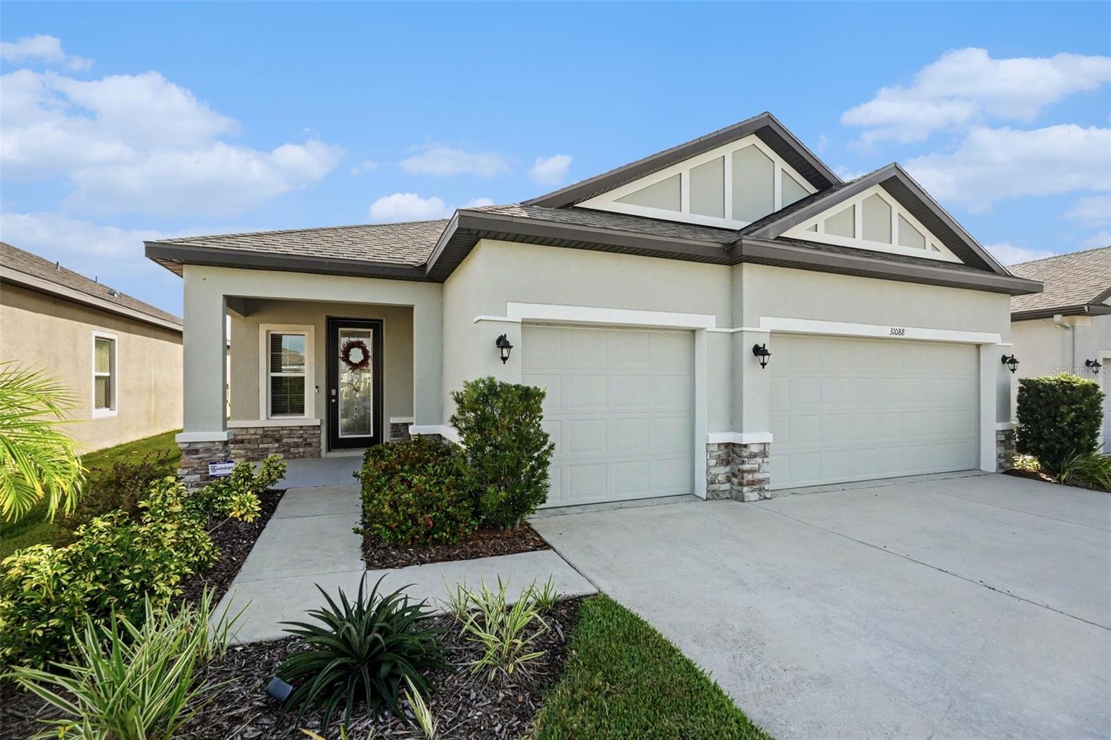 ASSUMABLE LOW-RATE MORTGAGE AVAILABLE—SLASH YOUR MONTHLY PAYMENT! Why settle for high market interest rates when you can step right into an incredible financing opportunity on this stunning 2021-built home at 31088 Jazz Leaf Pl? Welcome to an inviting interior entered through a full lite front door and featuring sleek tile flooring throughout. The heart of the home boasts a chef-inspired kitchen equipped with rich 42-inch cabinets, premium granite countertops, and an enhanced lighting package, alongside a versatile flex space ideal for an office or media den. Unwind in the spacious primary suite highlighted by an elegant tray ceiling and an ensuite master bath with full tile finishes, then step outside to relax on your oversized screened lanai overlooking a fully fenced yard. Situated in San Antonio’s premier master-planned community of Mirada, this property pairs unbelievable financial savings with elite Florida resort living. Nestled just off SR-52 with quick access to I-75, you're perfectly positioned near Wesley Chapel's top shopping, dining, and downtown Tampa. Beyond the backyard, dive into Mirada's iconic 15-acre Crystal Lagoon, multi-modal golf cart trails, dog parks, playgrounds, and ultra-fast speed ULTRAFi internet. Premium location, luxury community amenities, custom interior finishes, and a lower monthly payment—schedule your tour today before this exceptional opportunity is gone!