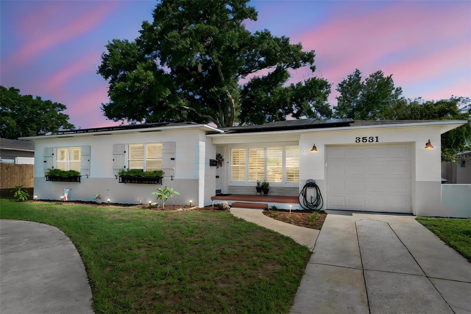 Charming and beautifully maintained 2-bedroom, 1-bath ranch home in the heart of Central St. Petersburg, blending character, style, and exceptional outdoor space. Inside, the home feels bright and inviting, with woodlook tile flooring throughout. A mix of plantation shutters and shutter style blinds adorn the windows. A versatile bonus room offers additional living space and could be used as a home office or formal dining area.The metro-modern kitchen is full of character, featuring exposed electrical conduit, stainless appliances, brick accents, a contemporary chandelier, durable butcher-block countertops, and a contrasting island with Coriancountertop.Step outside to a truly special shaded backyard retreat beneath a mature oak tree, surrounded by lush ferns, elephant ears, and established landscaping. The oversized, fully fenced lot offers plenty of space forentertaining, gardening, recreation, boat or RV storage, or creating your own private oasis with room for a pool. A spacious circular driveway provides ample off-street parking for family and guests.Additional highlights include a fully owned solar panel system, newer water heater, updated electrical, updated bathroom, and a new roof installed in August 2023. Located in Flood Zone X. Ideally situated just minutesfrom Downtown St. Petersburg, the Central Avenue corridor, shopping, dining, parks, entertainment, Gulf Coast beaches, major commuter routes, and the interstate. Enjoy the charm of an established neighborhood withconvenient access to all that St. Petersburg has to offer. A home with character, updates, abundant outdoor space, and plenty of possibilities... come see it for yourself!