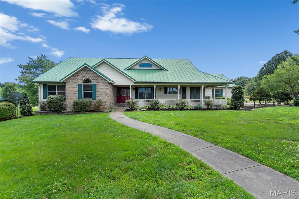 An absolutely beautiful home with over 4,300 square feet of finished space on a ready-for-horses 6.06 acres. This stunning ranch home offers an open floor plan with soaring ceilings, 4 bedrooms, and 3.5 bathrooms. Two gas fireplaces—located on the main level and in the finished lower level. Laundry rooms on both levels provide added convenience for everyday living. The beautifully updated kitchen features granite countertops and custom glazed cabinetry by Beussink, making it a standout gathering space. Enjoy peaceful views from the stunning sunroom or relax on the composite deck overlooking the large patio and pasture. The acreage is dotted with mature trees and includes three large shops, one specifically designed to accommodate an RV. Combining generous living space, quality updates, outstanding outbuildings, all in an awesome location, this property offers a rare opportunity to enjoy the best of country living.
