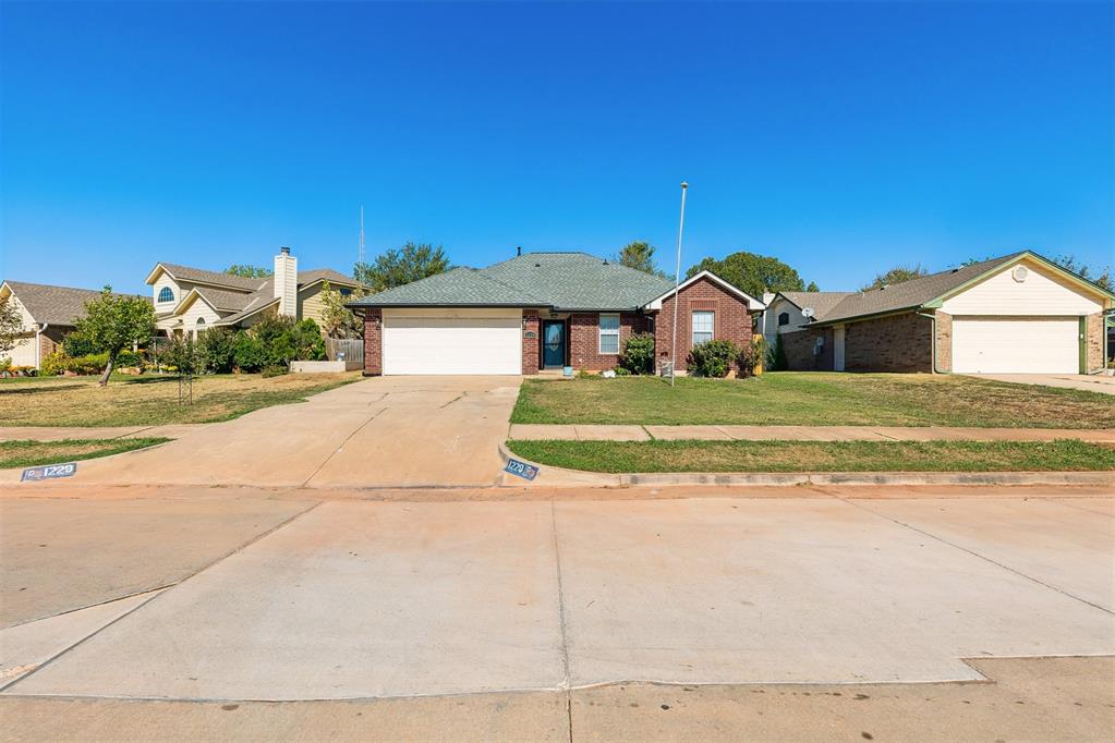 This move-in-ready, 4-bedroom, 2-bathroom home offers a spacious, private backyard and several recent updates! Inside, you'll find fresh paint and baseboards, newer laminate flooring, and new carpet in the bedrooms. The living room features a gas log fireplace and plenty of natural light. The kitchen has stainless steel appliances, and the refrigerator stays with the home. The spacious primary bedroom features a raised ceiling, large walk-in closet, and updated bathroom. The secondary bathroom has also been updated. Major improvements include a new roof and gutters approximately one year ago, an AC unit approximately two years old, a furnace approximately 3–4 years old, and a water heater replaced in 2020. Outside, enjoy a covered back porch overlooking the large, private backyard. Additional features include a two-car garage and storm shelter. With several updates already completed, this home is ready for its next owner!