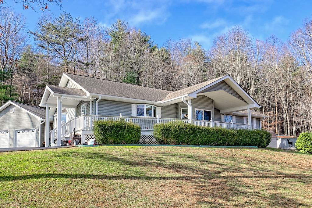 Exceptional home in the heart of Young Harris with year-round and seasonal mountain views. Paved access to the 2-car garage and entry. The residence features 3 bedrooms, 2 full baths on one level situated on 1 unrestricted acre.  The inviting entry opens into the formal living area and great room both with a fireplace offering excellent space for gathering.  The kitchen has a ton of storage, excellent counter and prep space with views.  The dining area just off the kitchen and formal living with a bay window captures the views as well.  There is a side entry into the mudroom and kitchen.  There are 2 guest suites with a shared bath and a primary suite with an ensuite bath and a walk-in closet. The 2-car garage has a full bath, pull-down stairs for attic storage, a refrigerator, and tool cabinets. This home is in excellent condition. Additional features include wired for generator, gutter guards, wood-burning and gas fireplaces, dual-fuel heat, aluminum-clad Anderson windows, stainless steel appliances, solid wood doors, and window shades/blinds throughout.  Schedule your showing today for this Young Harris charmer.